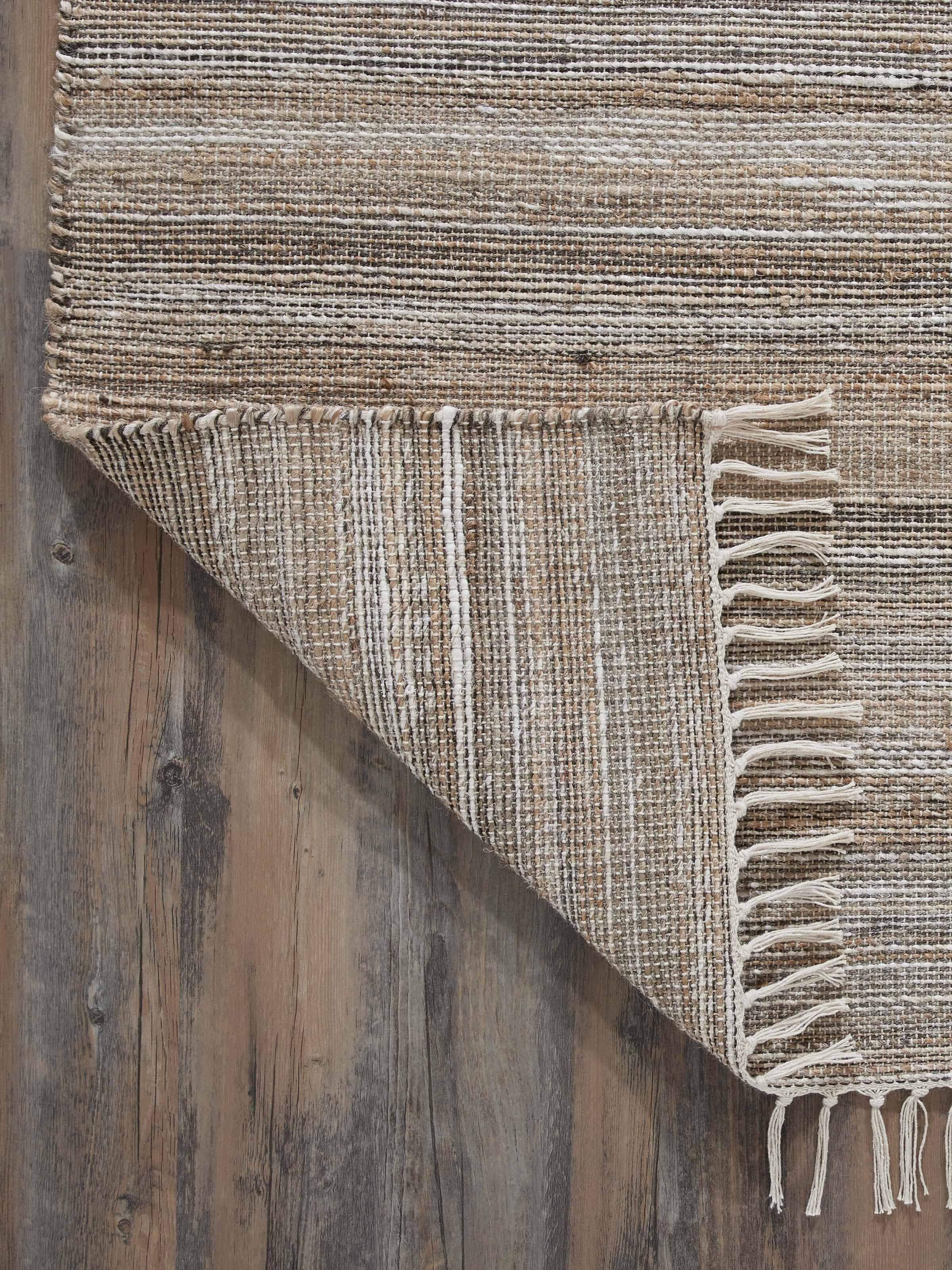 Full view of Textured Beige Black Lawan Jute & Cotton Rug on the floor, demonstrating its practical use and aesthetic appeal.