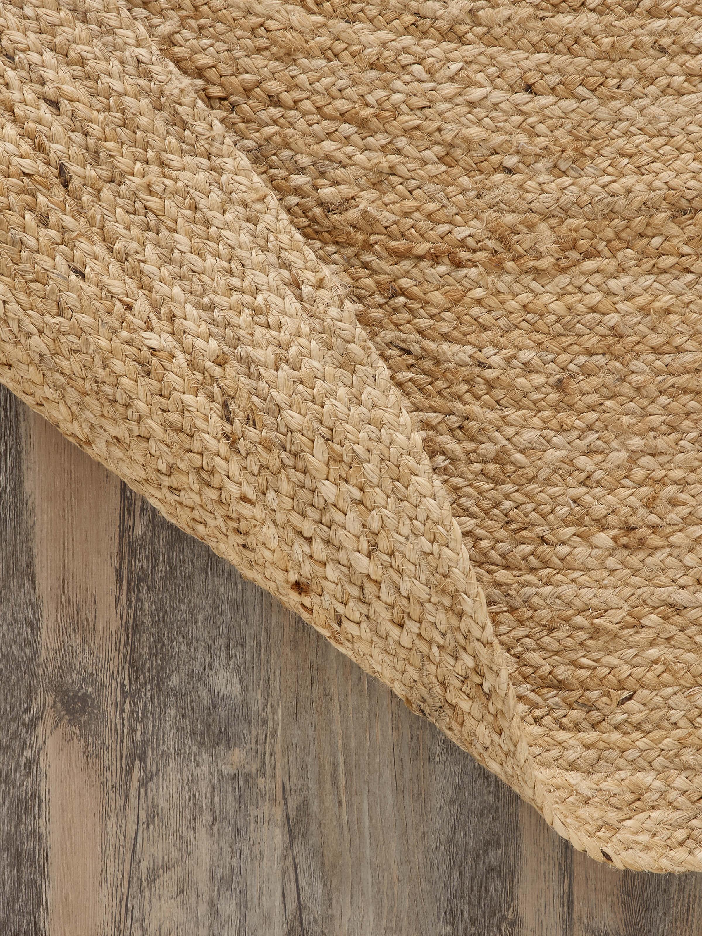 Top view of the braided round beige jute natural fibre rug, highlighting its round shape and braided pattern.