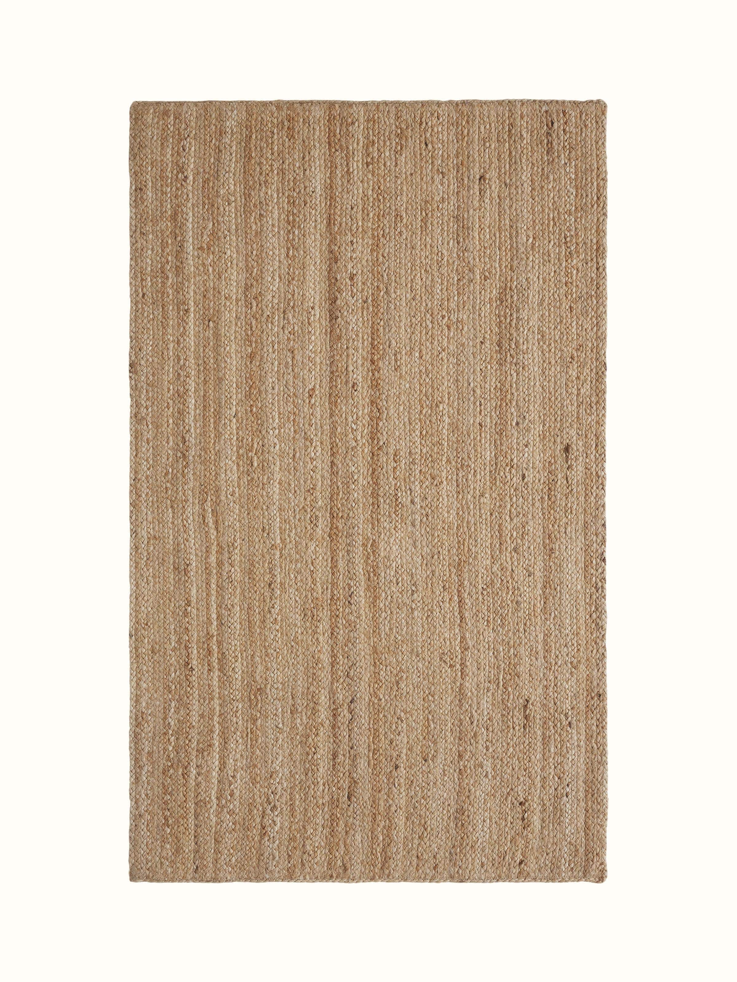 Braided stripe beige Lawan jute natural fibre rug, showcasing the texture and braided pattern.