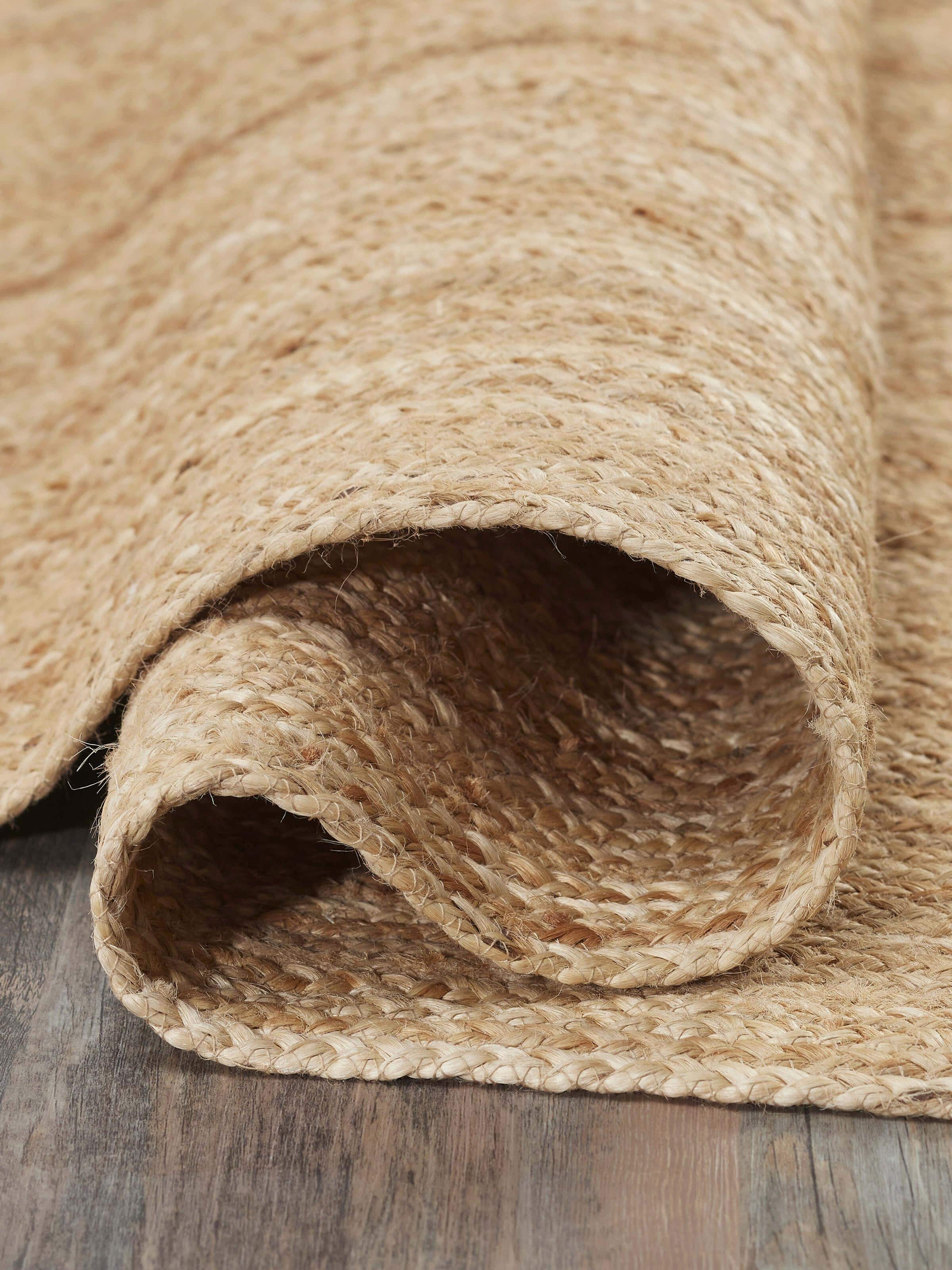 The braided stripe beige Lawan jute natural fibre rug, featuring a detailed view of the braided pattern and edges.