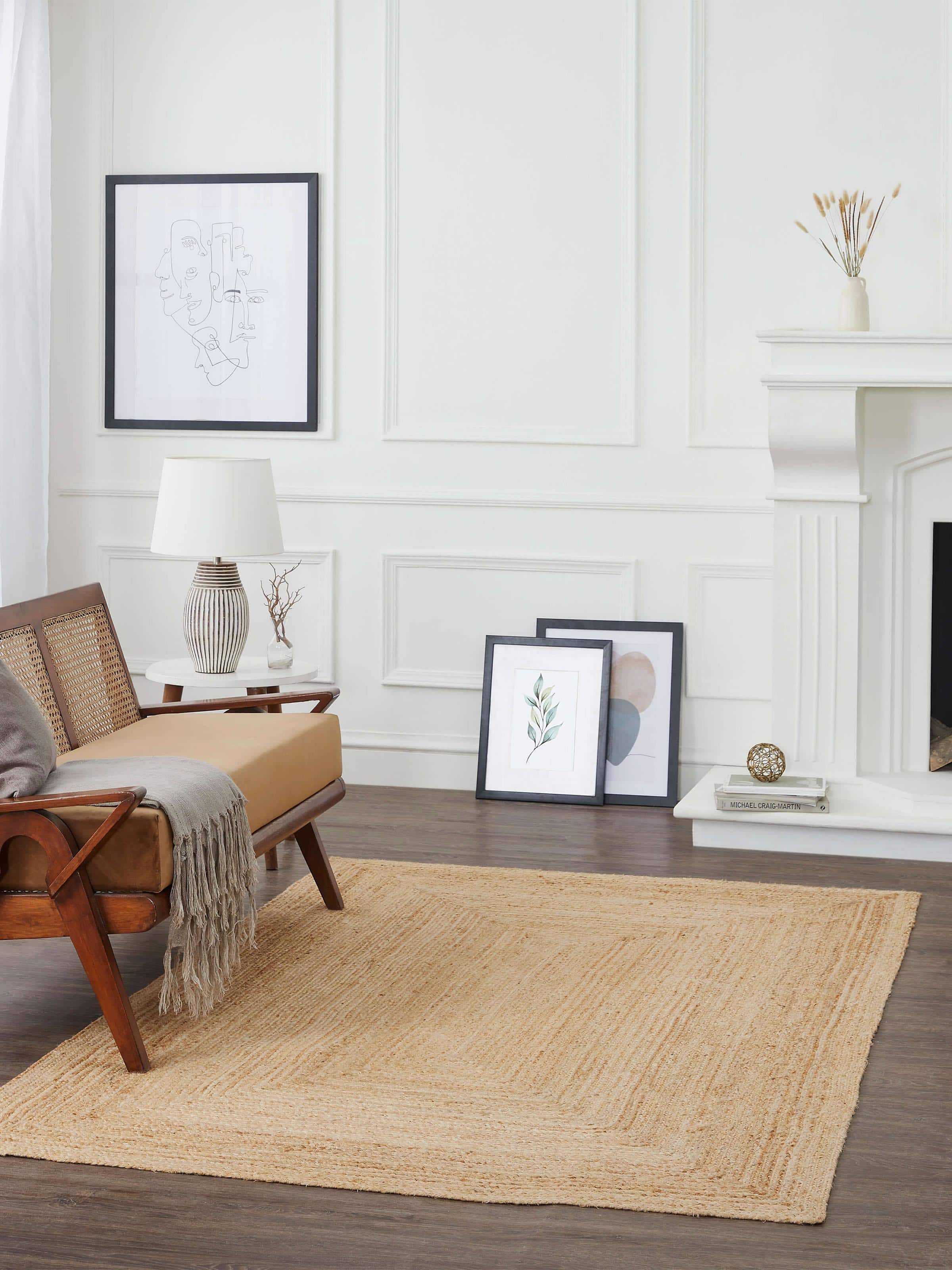 Close-up of braided concentric rectangle beige Lawan jute rug, highlighting the texture and natural fiber details