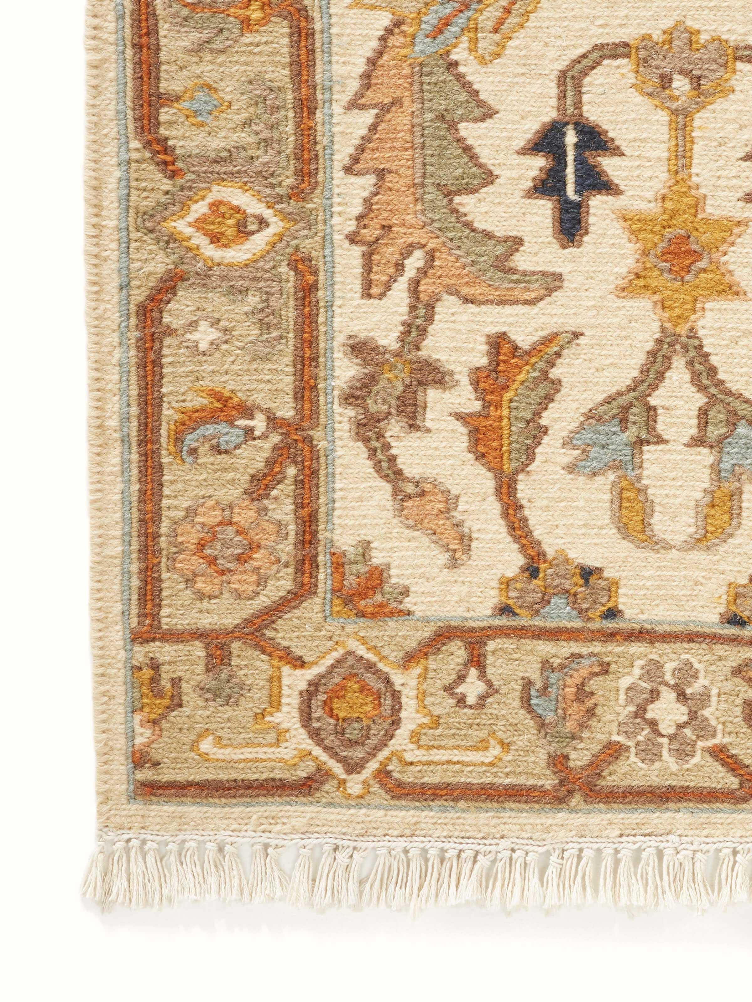 Close-up view of Nomad traditional off-white Bhadohi wool hand-knotted runner showing the texture and detailed patterns.