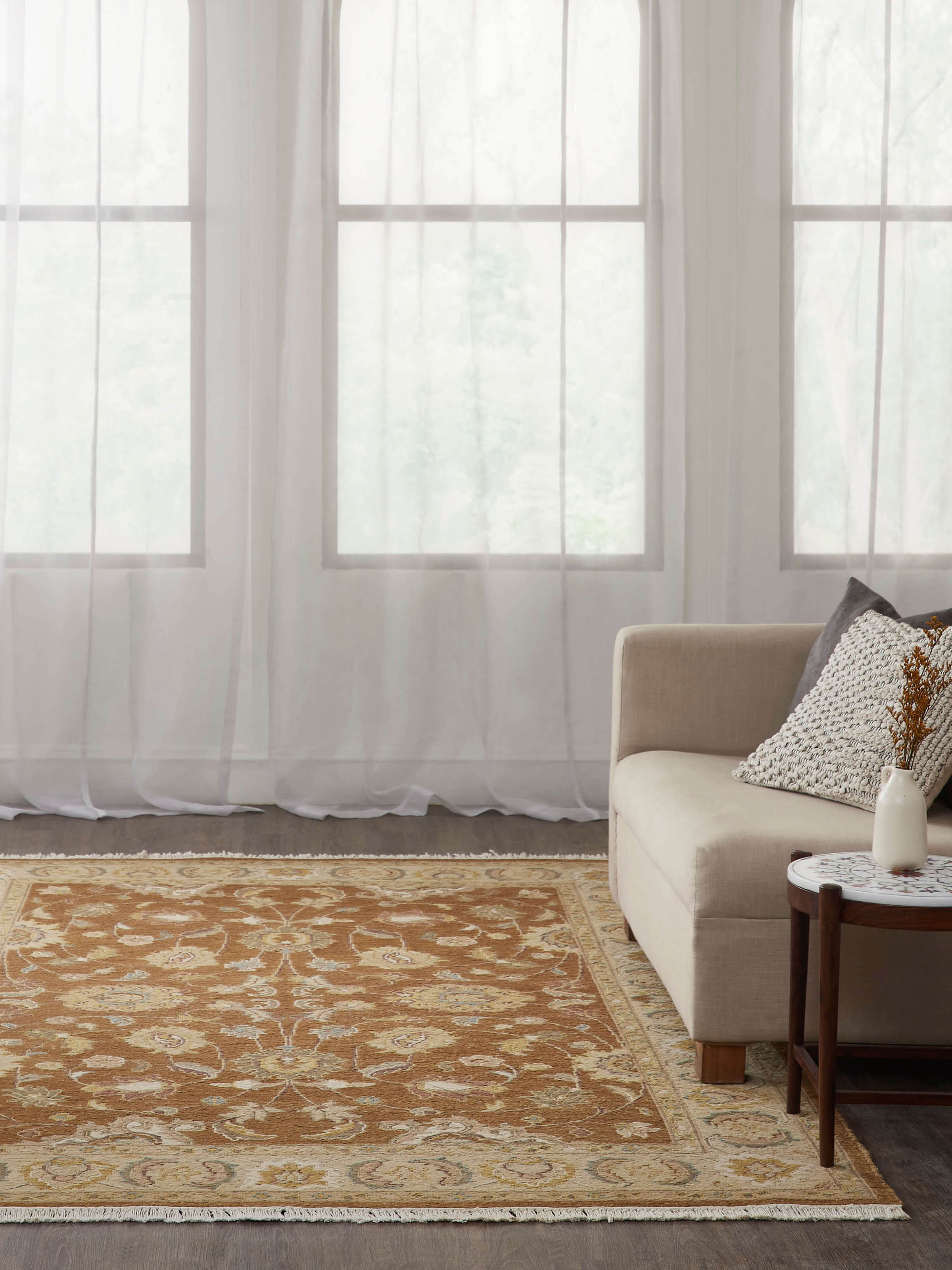 Lifestyle shot of Persian Sumak Charbagh rug in warm brown tones, hand-knotted in Bhadohi with detailed traditional motifs.