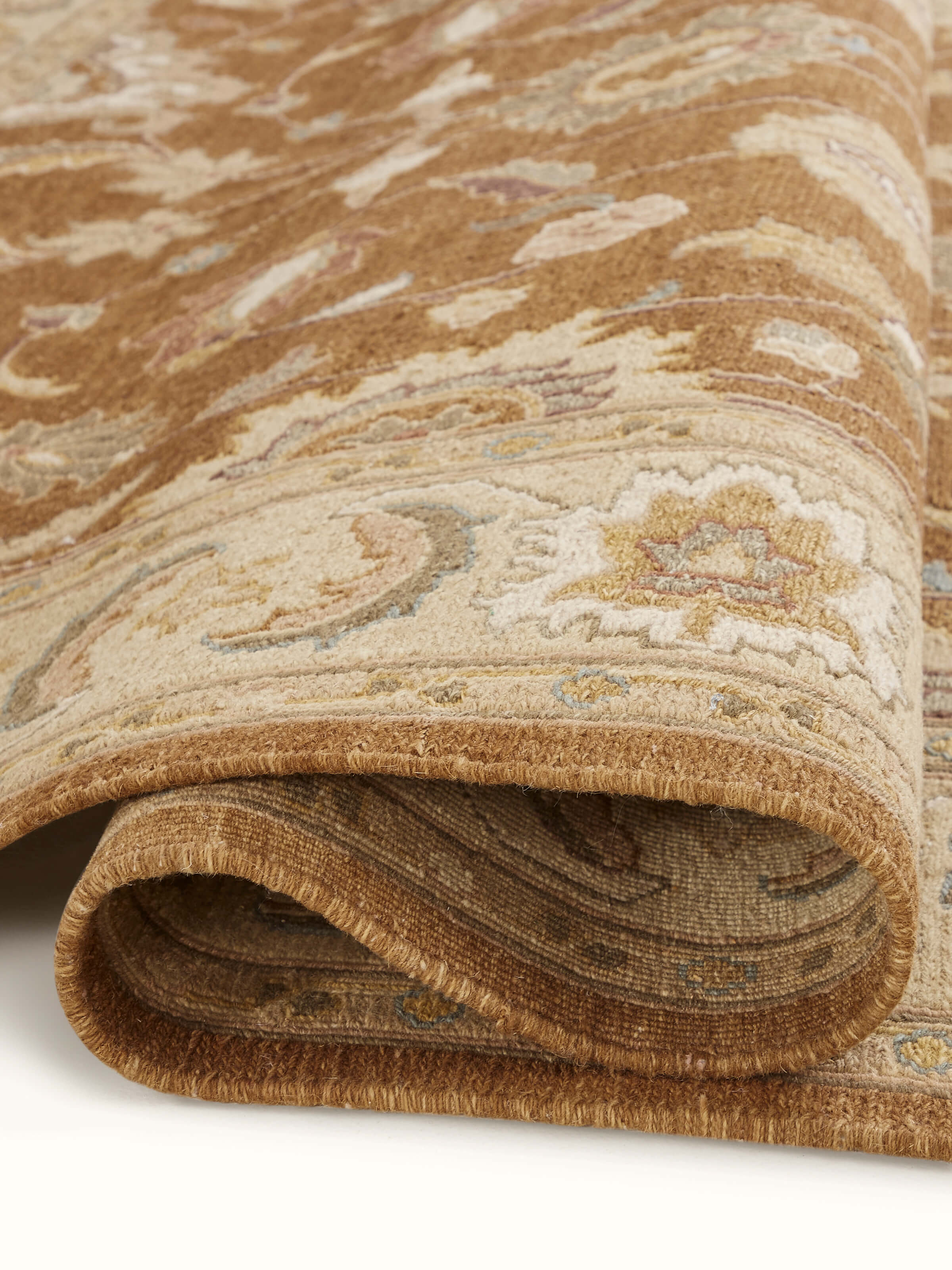 Side view of Traditional Sumak brown Charbagh Bhadohi rug showing the thickness and edge details