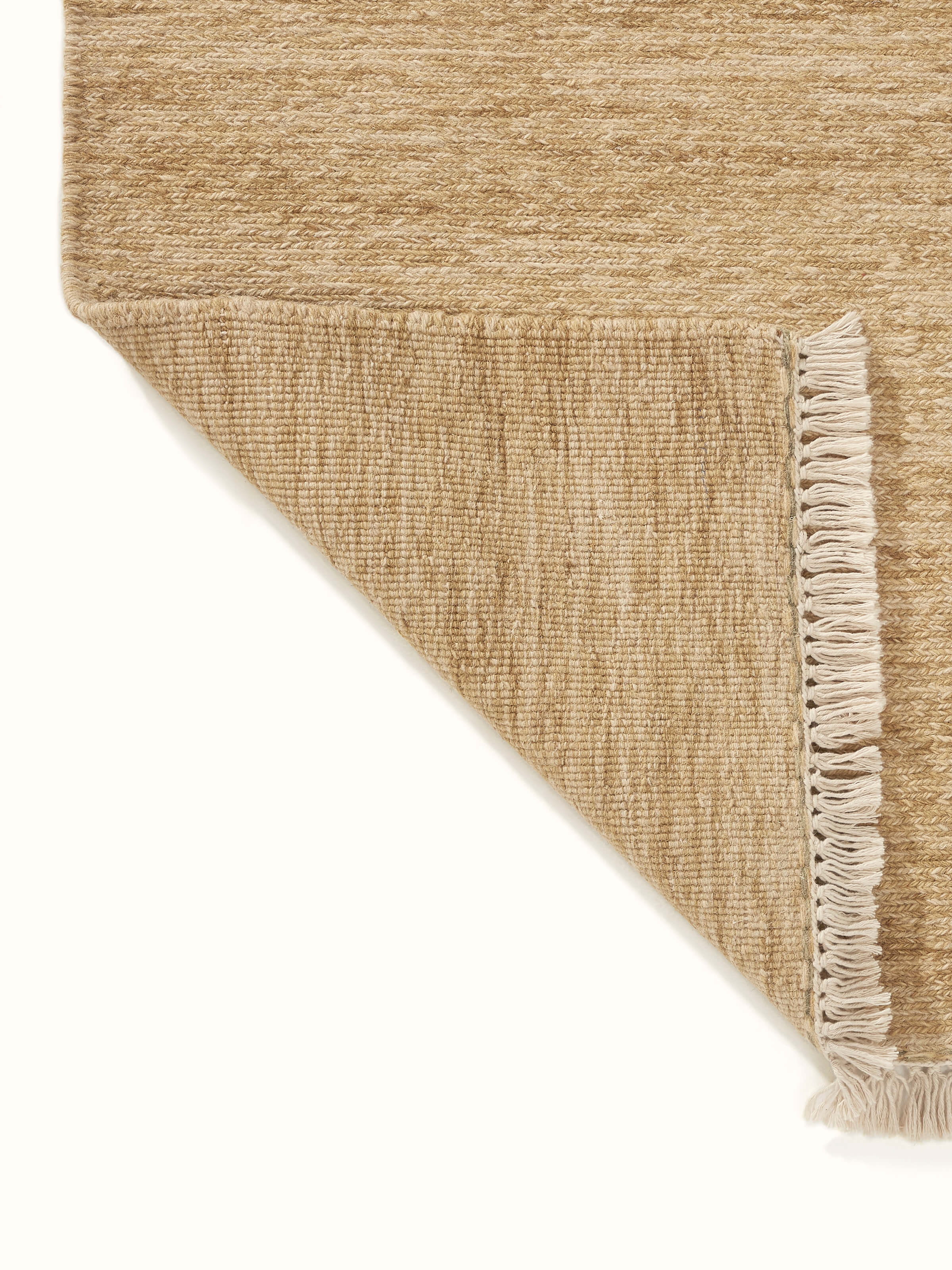 Detailed shot of the Sumak beige Bhadohi wool hand-knotted rug, emphasizing the rug's quality and texture