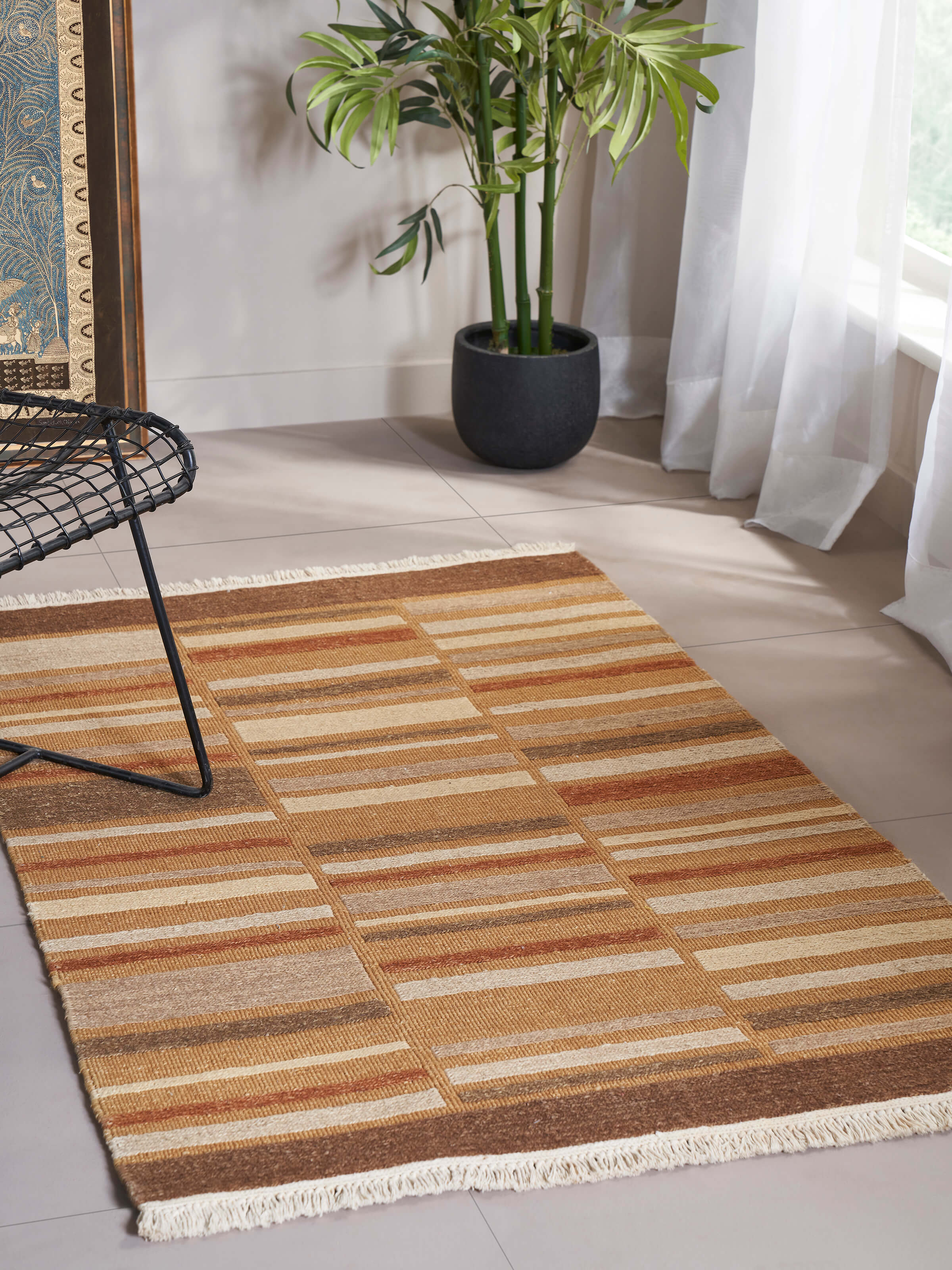 Close-up view of Geo solid textured sumak rust Bhadohi wool hand-knotted rug highlighting the detailed texture and craftsmanship.