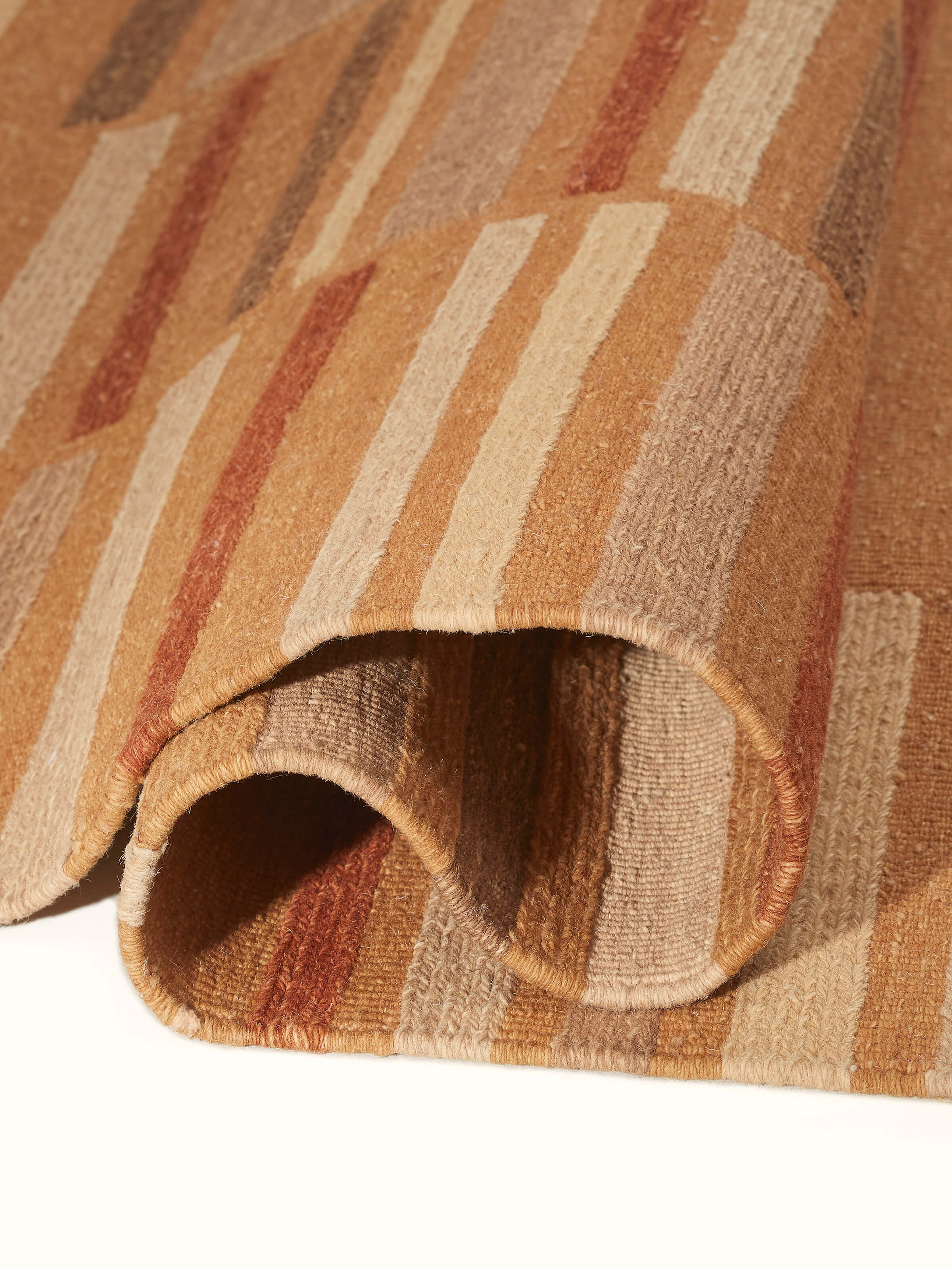 Perspective view of Geo solid textured sumak rust Bhadohi wool hand-knotted rug showing the overall design and color richness.