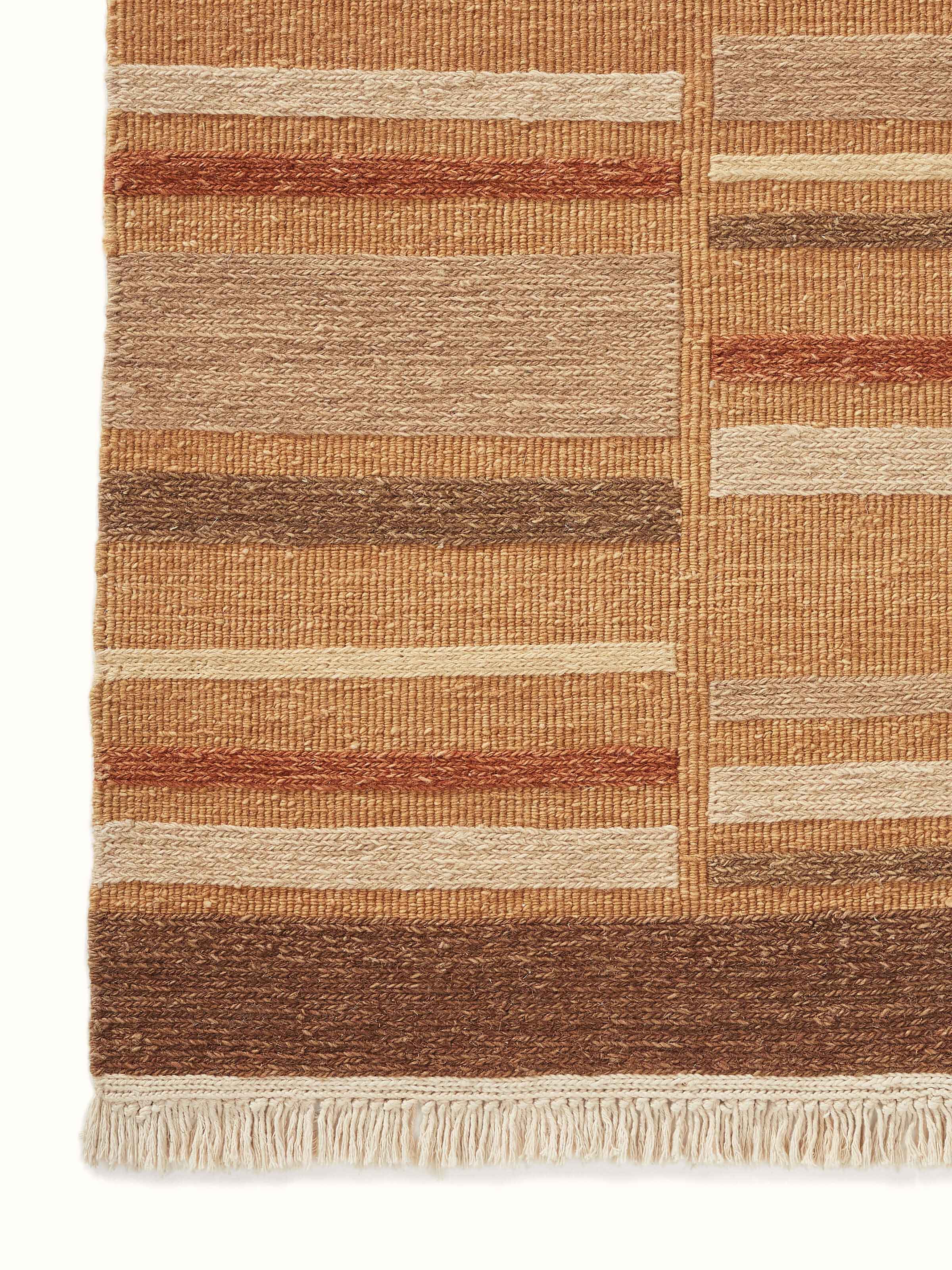 Full view of Geo solid textured sumak rust Bhadohi wool hand-knotted rug, emphasizing the solid color and fine texture.