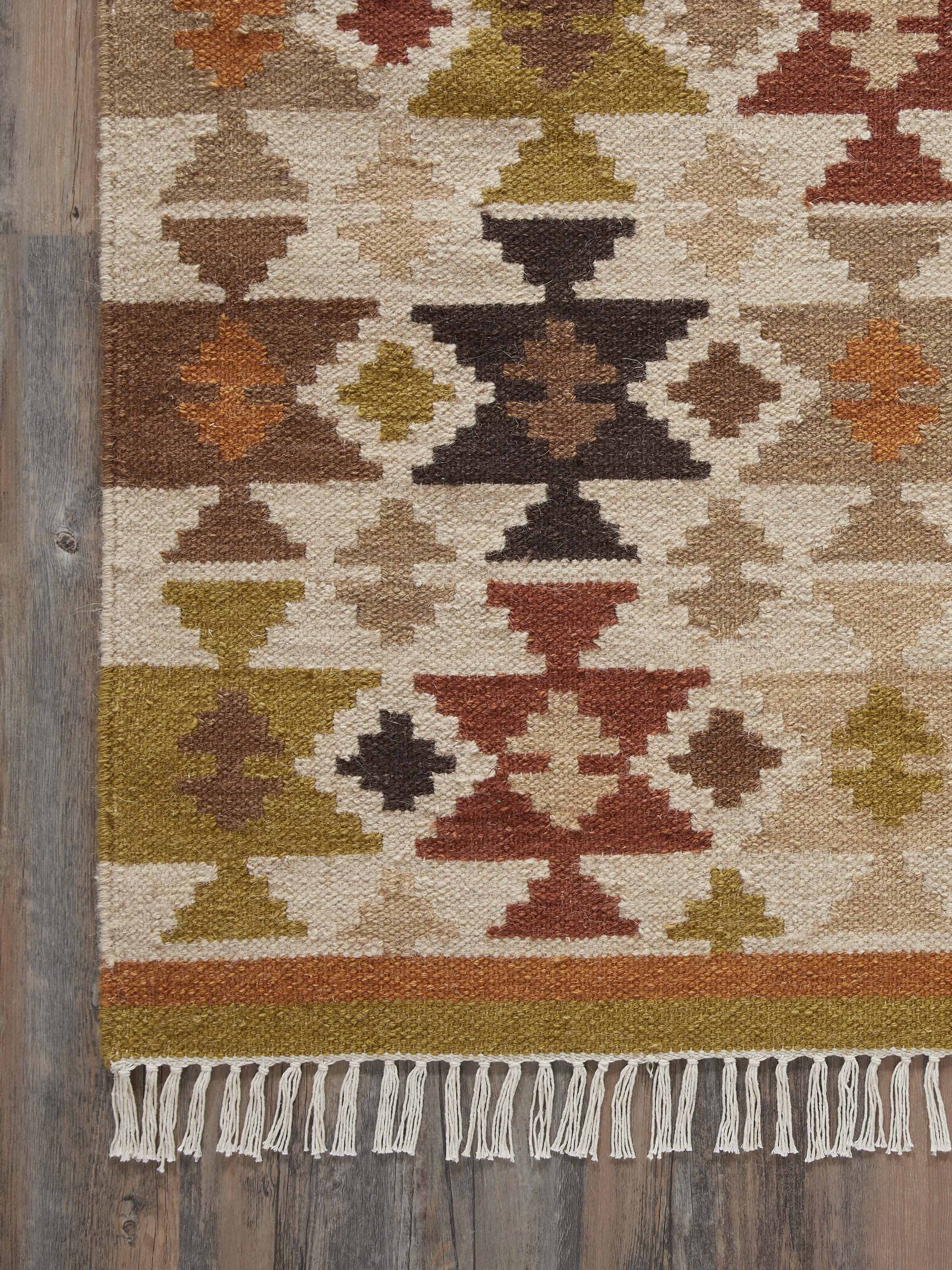 Perspective view of Graphic Geo Green Lawan wool panja dhurrie showing the overall design and green hues.