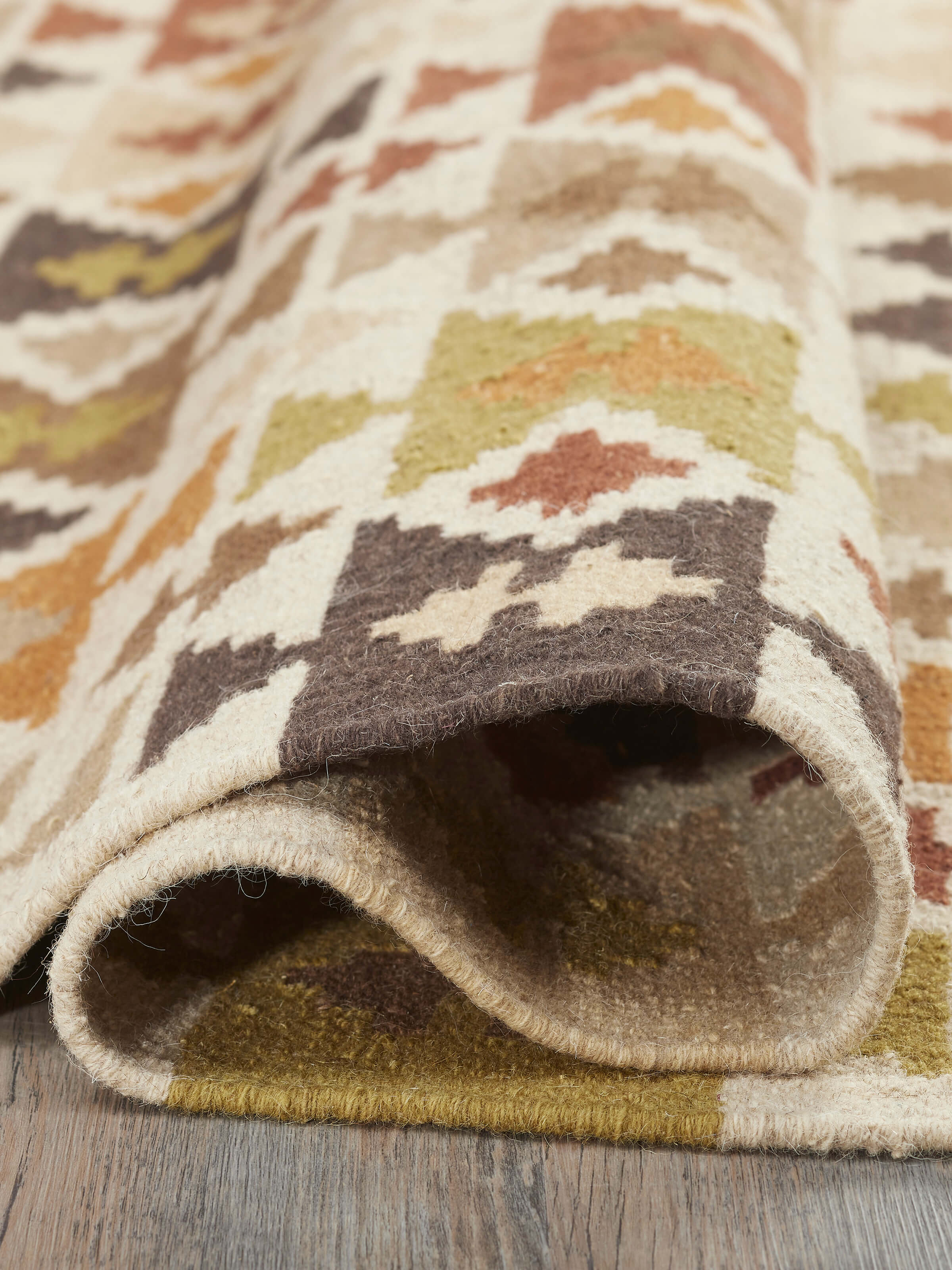 Full view of Graphic Geo Green Lawan wool panja dhurrie emphasizing the geometric pattern and wool texture.