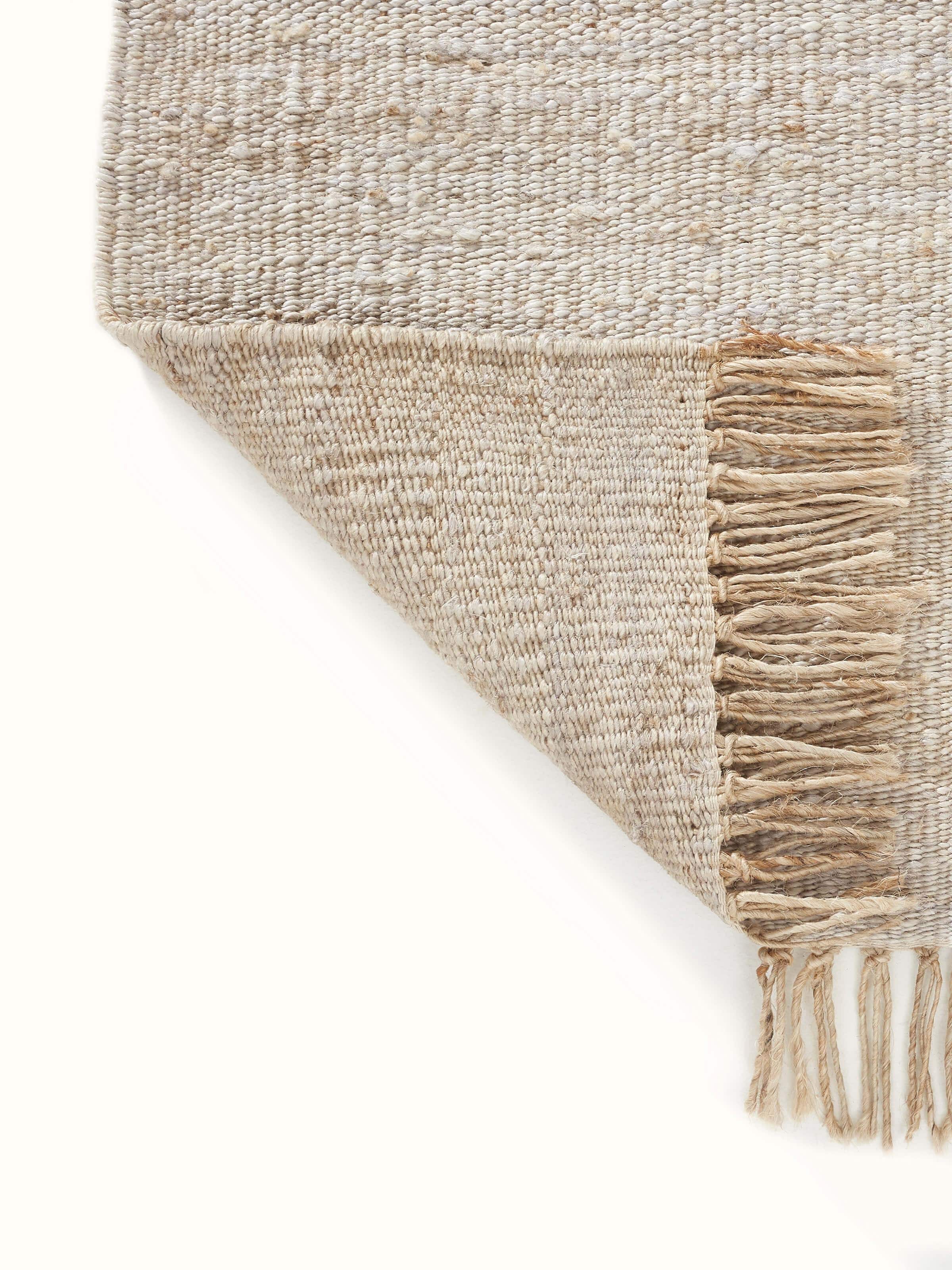 Close-up view of Graphic geo beige grey jute natural fibre rug focusing on the color and pattern