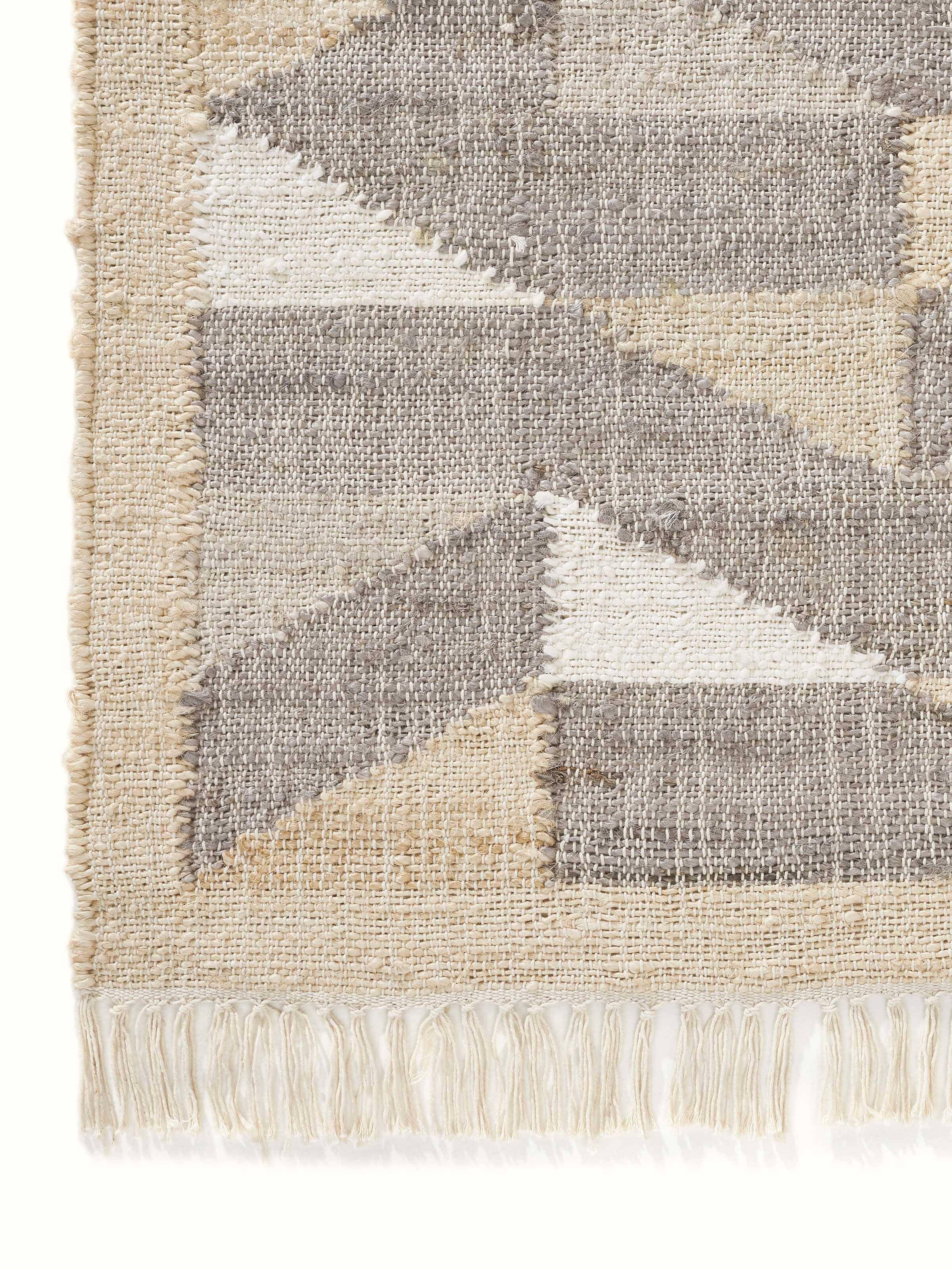 Graphic geo beige brown jute natural fibre rug in a living space, showcasing its design and natural look.