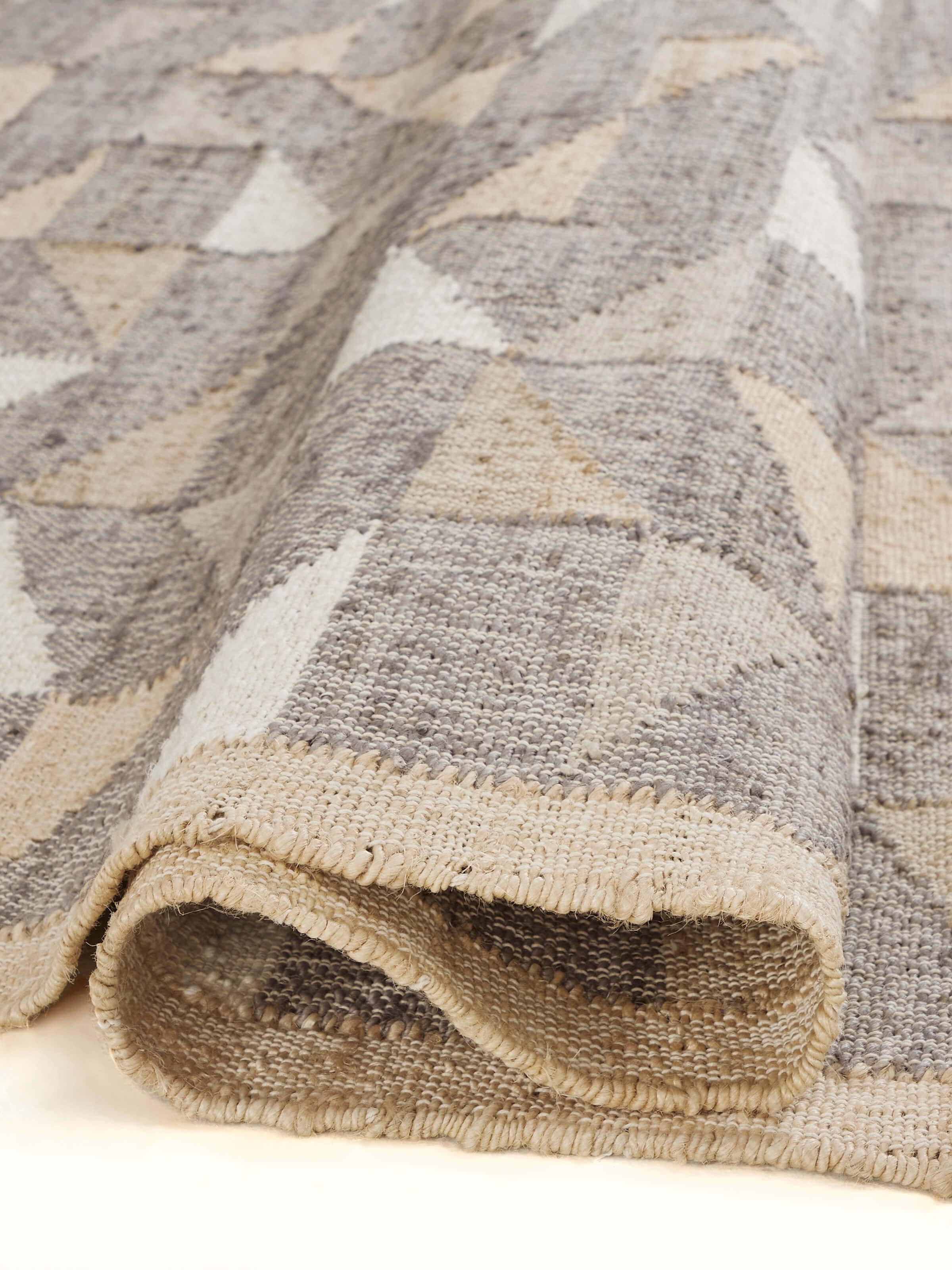 Detailed view of Graphic geo beige brown jute natural fibre rug, emphasizing the intricate geometric patterns and texture.