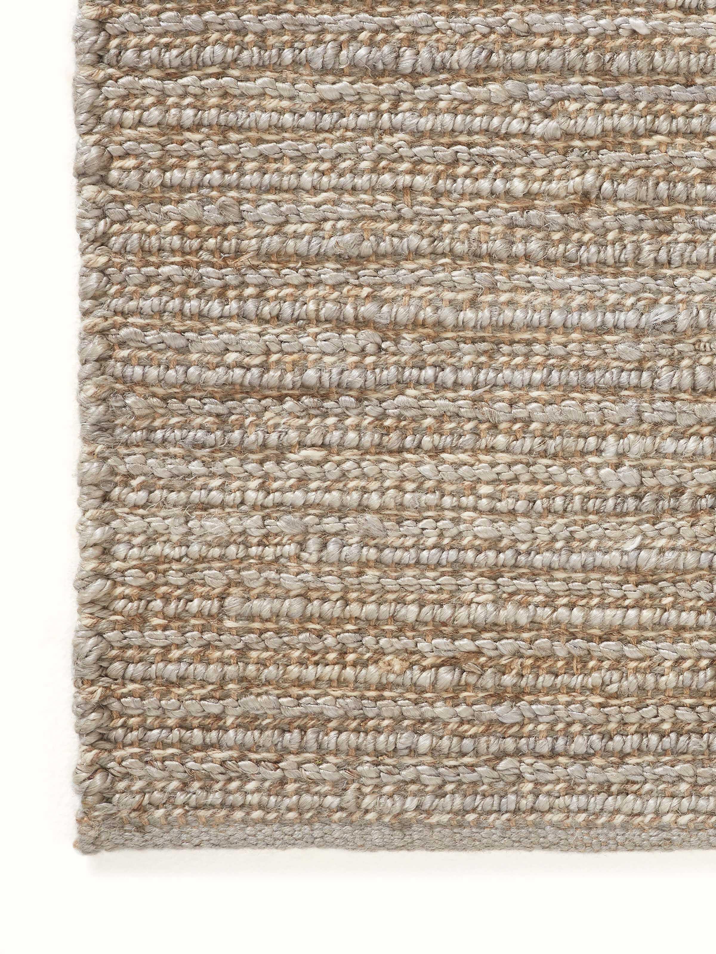 Detailed view of the Textured Solid Grey Jute & Wool Rug, showing its grey hue and woven texture.