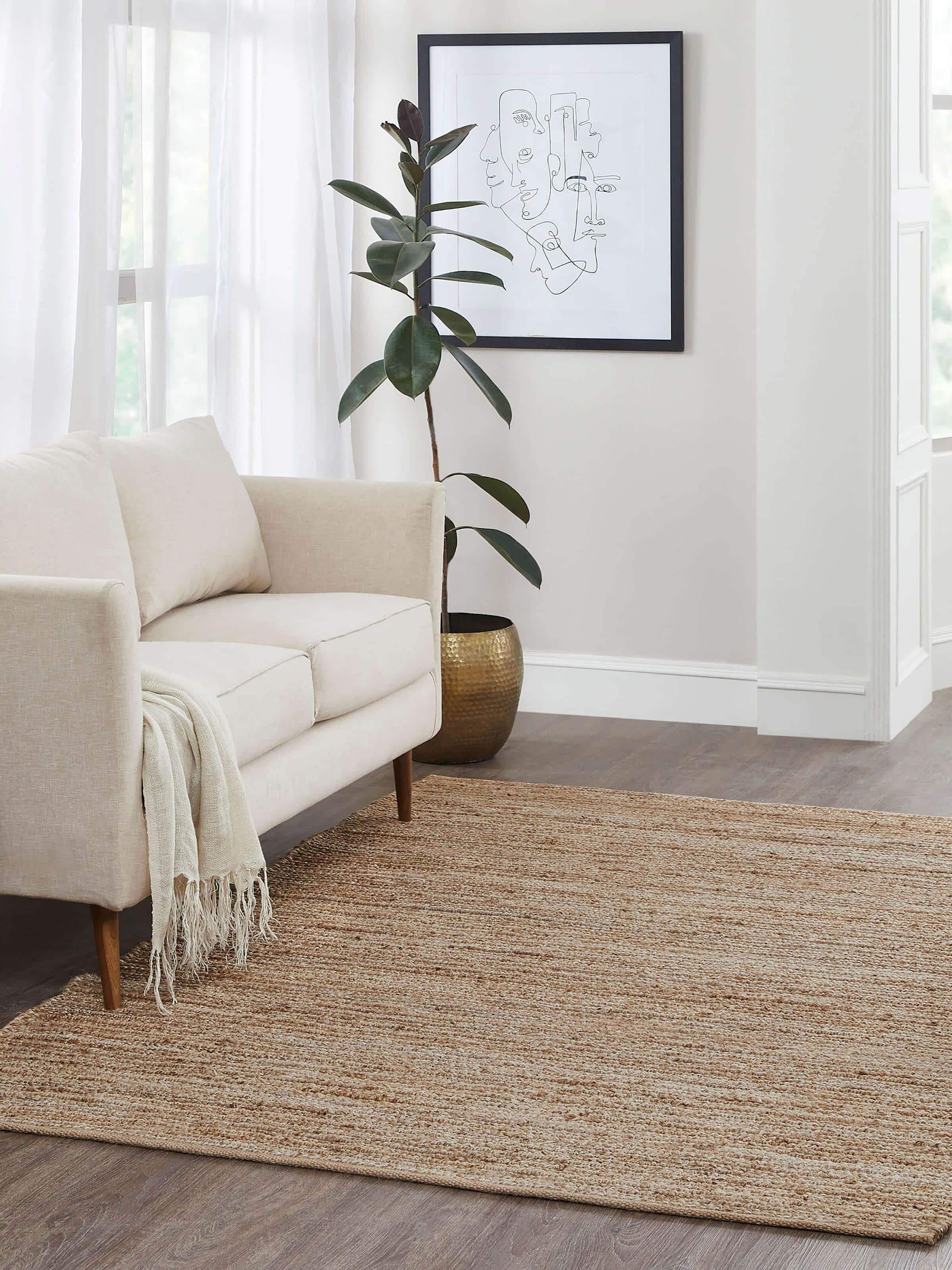 Living room styled with solid beige jute rug in natural fibre, measuring 5x8 ft.
