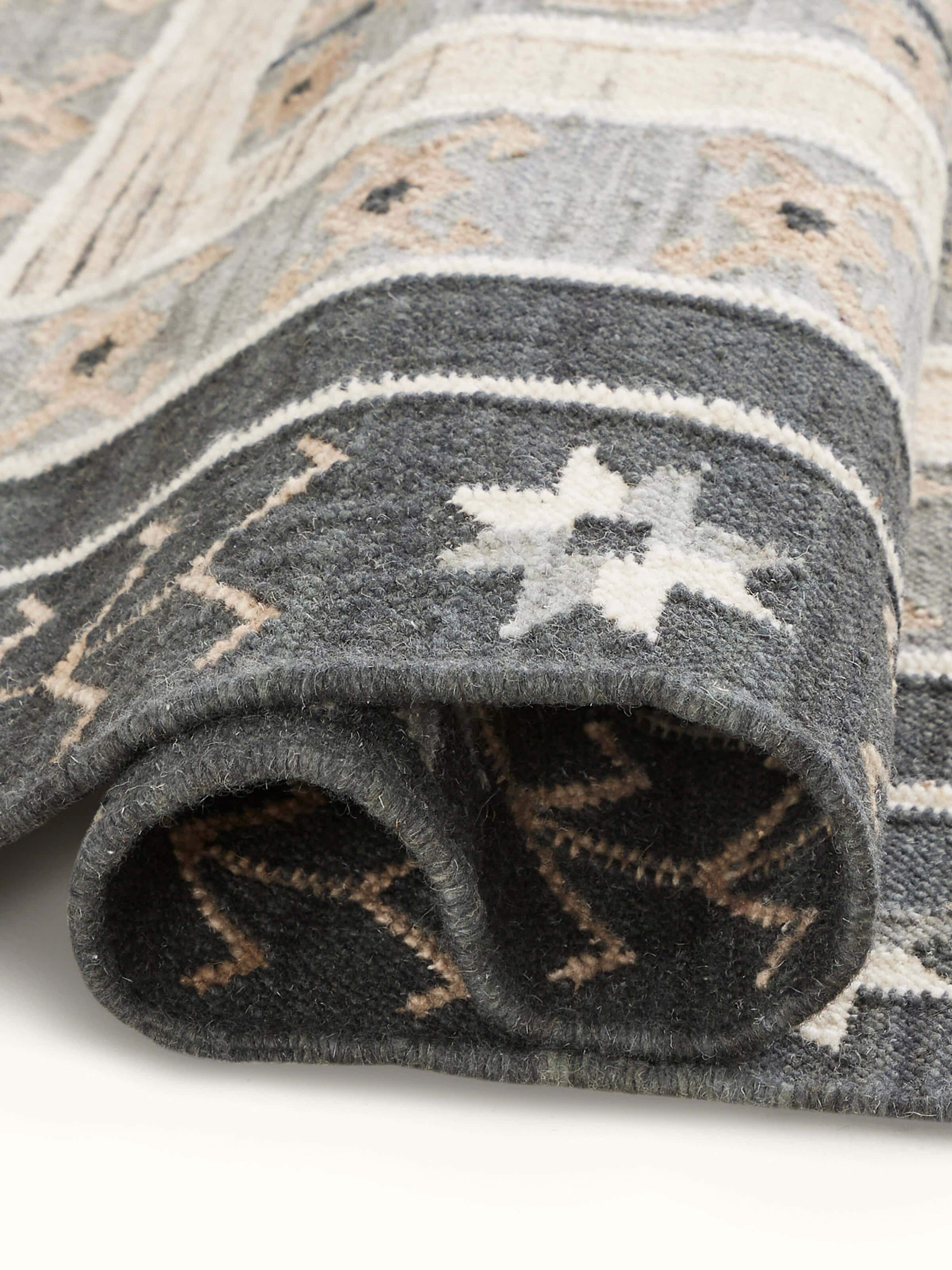Close-up of Contemporary geo grey wool panja dhurrie showing the wool texture and design detail.