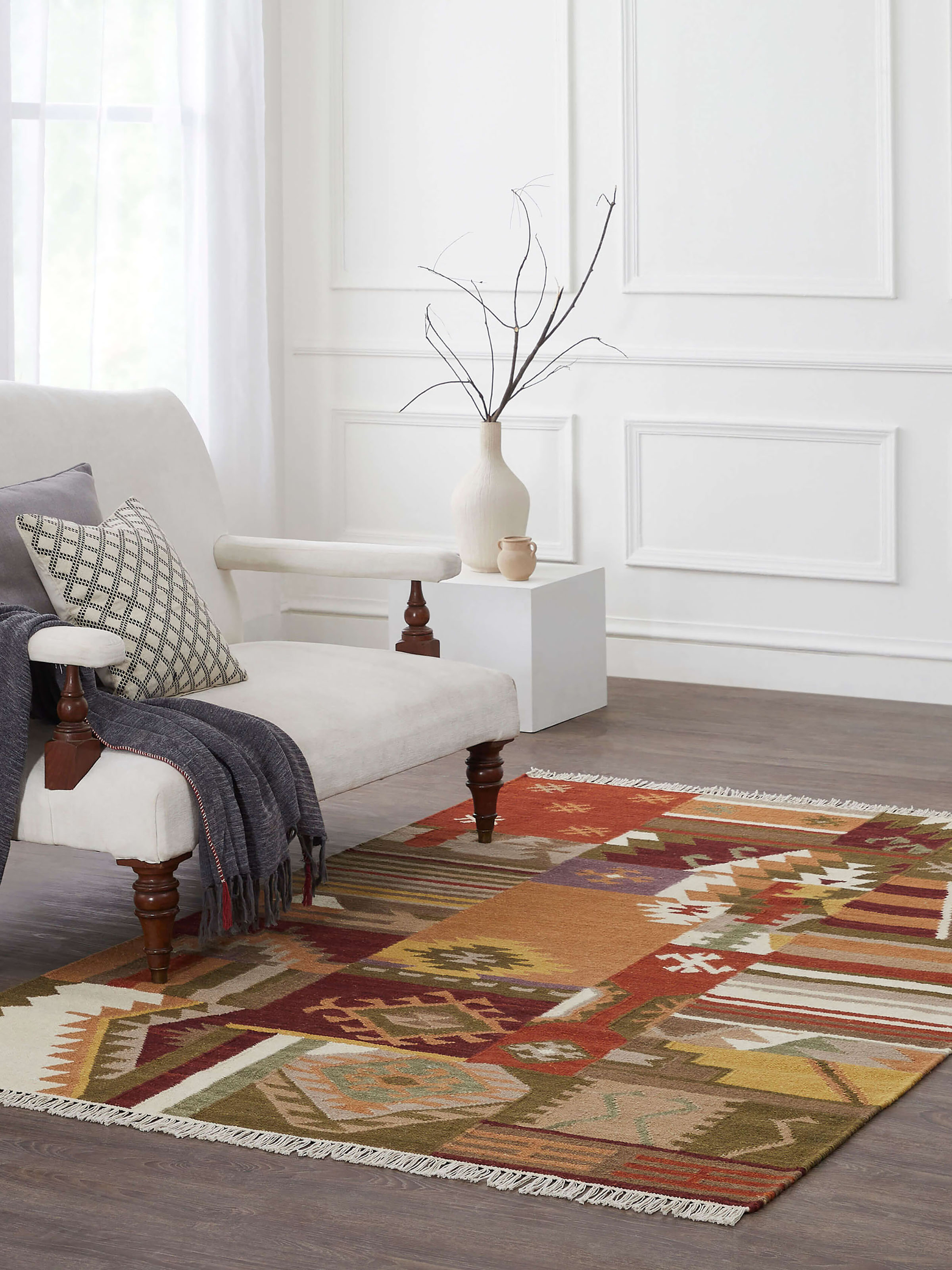 Lifestyle image of vibrant orange Kilim Patchwork Wool Dhurrie with bold geometric panja weave, adding a traditional yet modern touch to flooring.