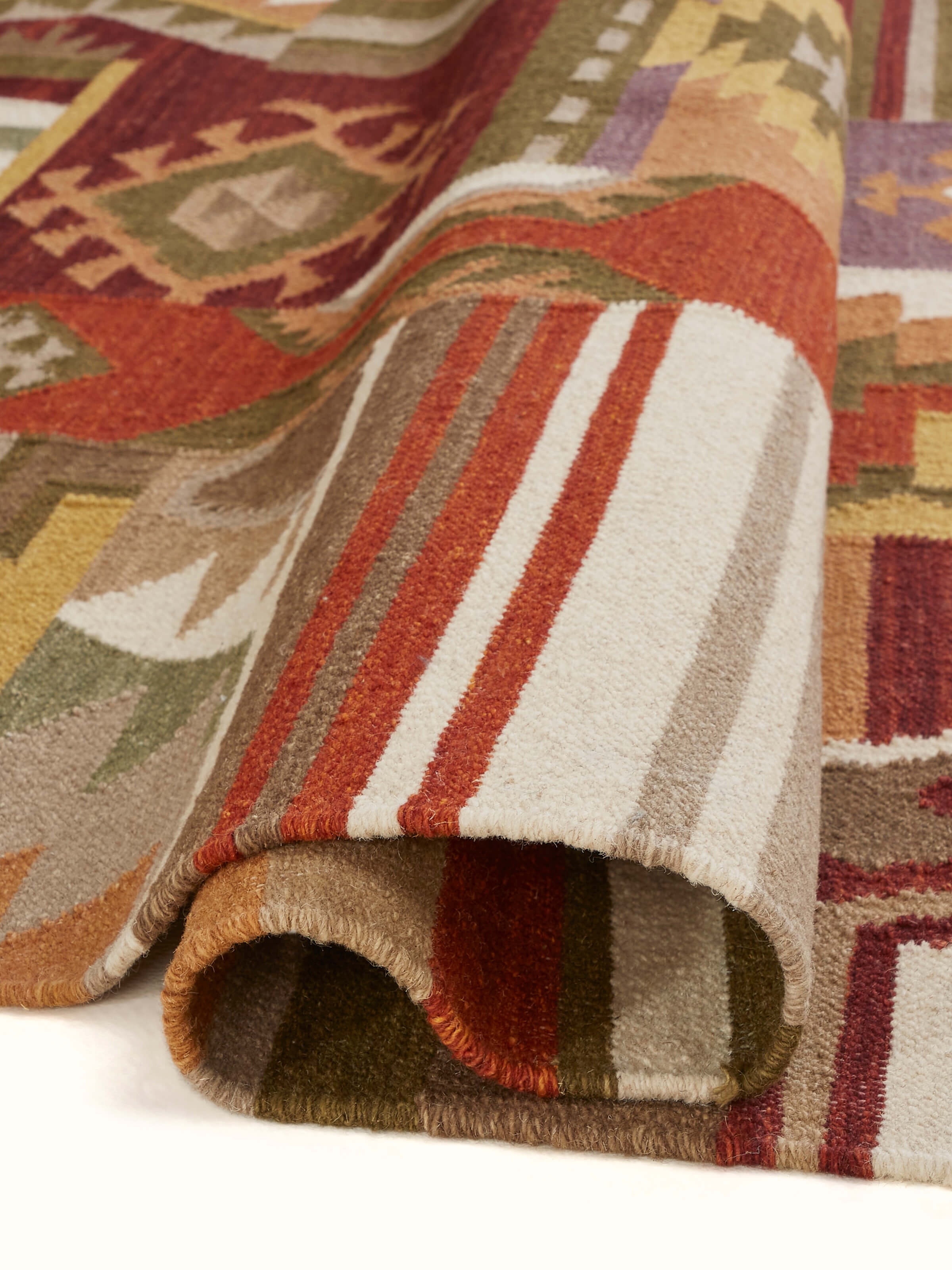 Side view of Kilim Patchwork Orange Wool Panja Dhurrie, showing the thickness and texture of the wool.