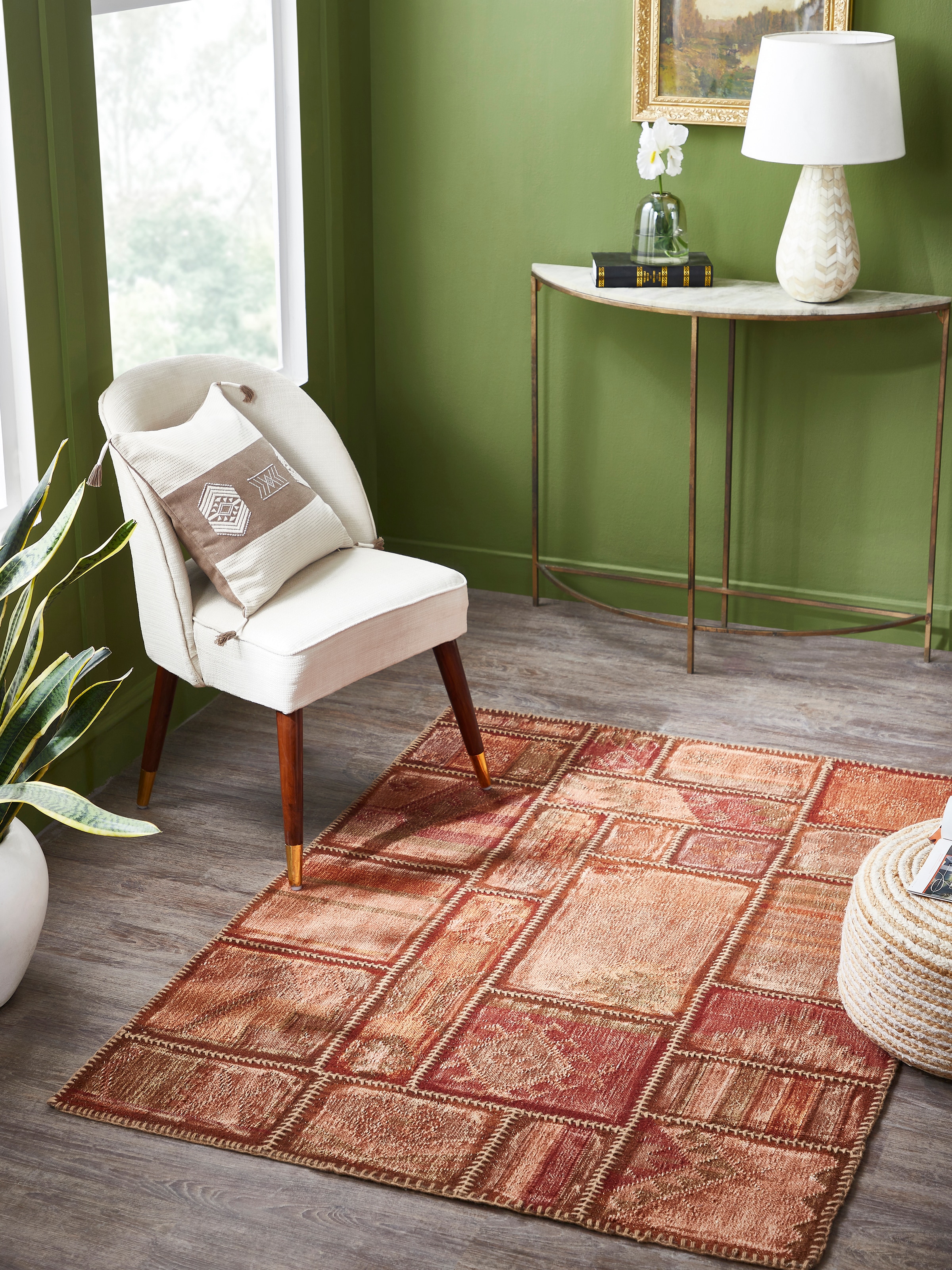 Lifestyle image of Kilim patchwork dhurrie in antique red tones made with Panja weaving technique