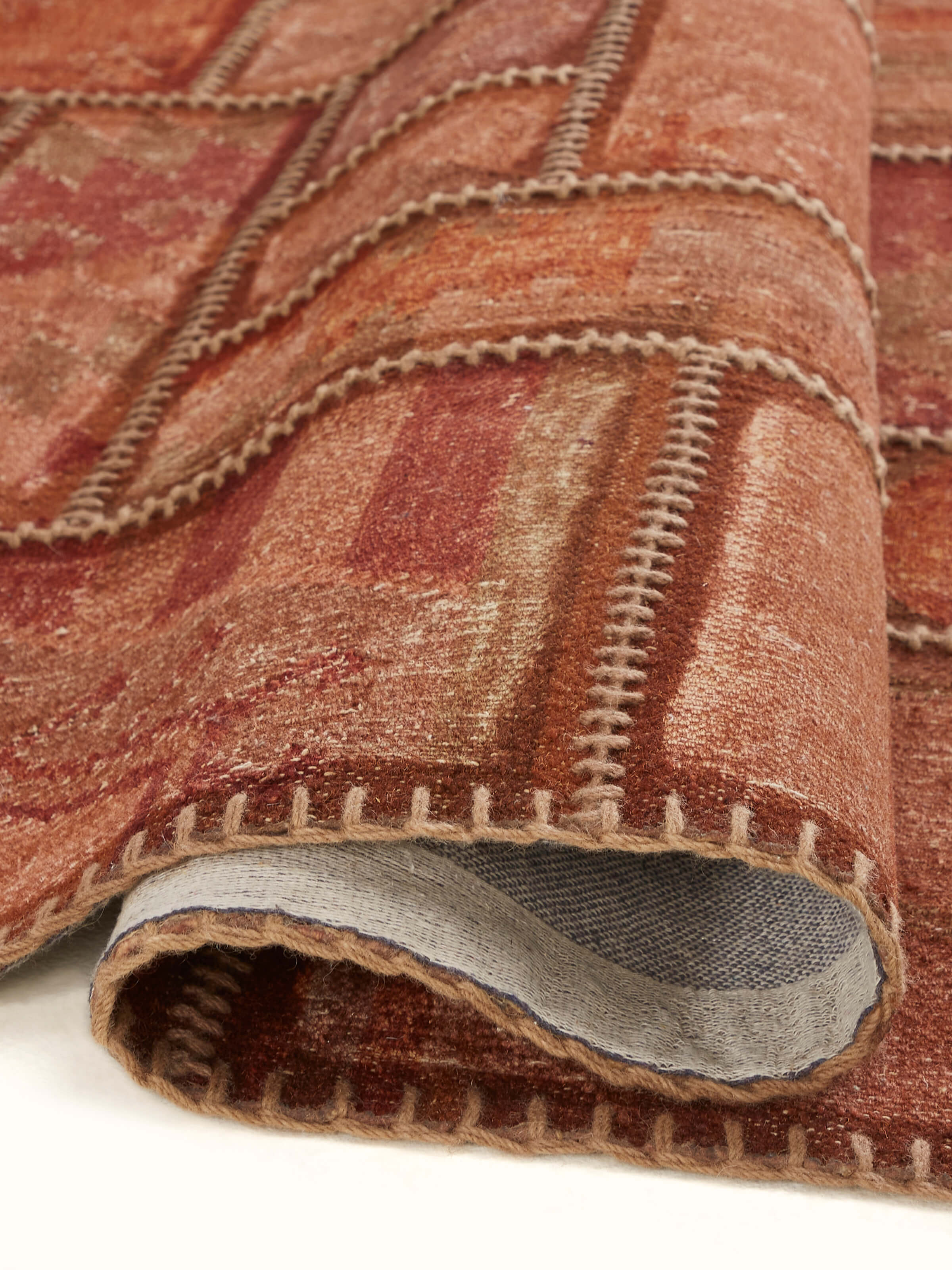 Kilim patchwork antique red wool panja dhurrie in a room setting, showcasing its use and overall aesthetic appeal