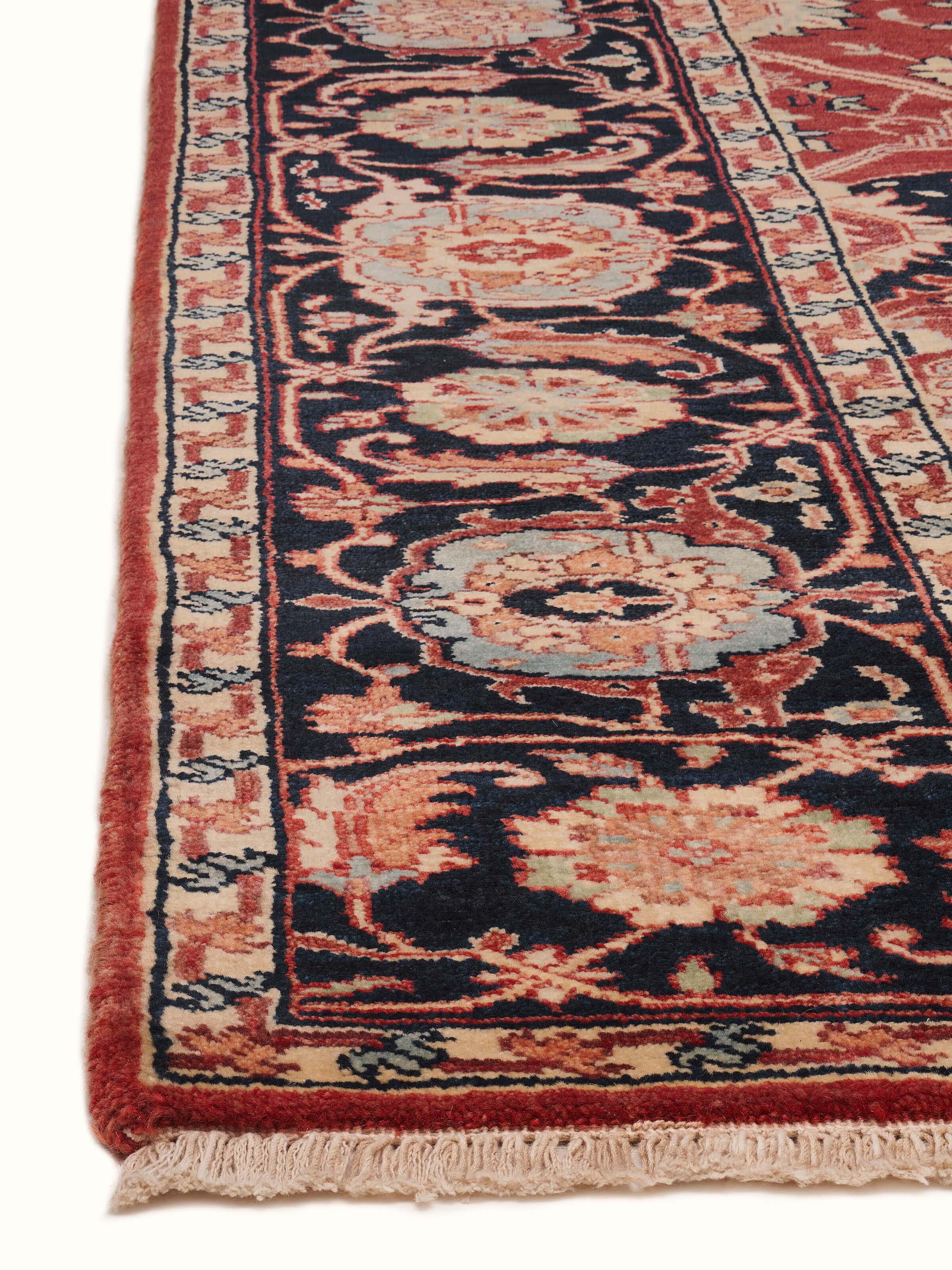 Detailed view of the Traditional Heriz red Bhadohi wool hand-knotted rug, focusing on the craftsmanship and pattern.