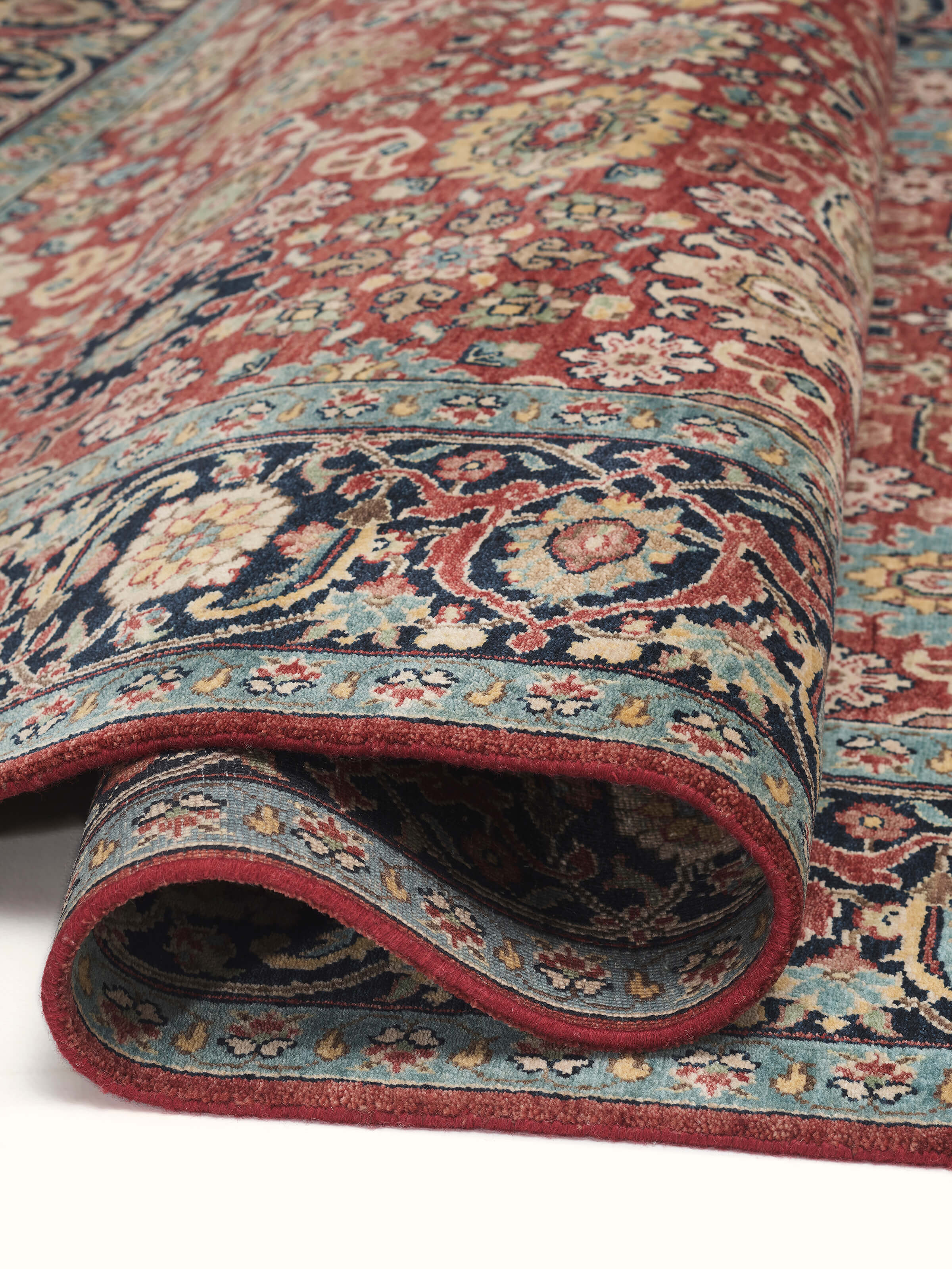 Detailed view of Traditional mahal red Bhadohi wool hand-knotted rug showing the rich colors and intricate patterns