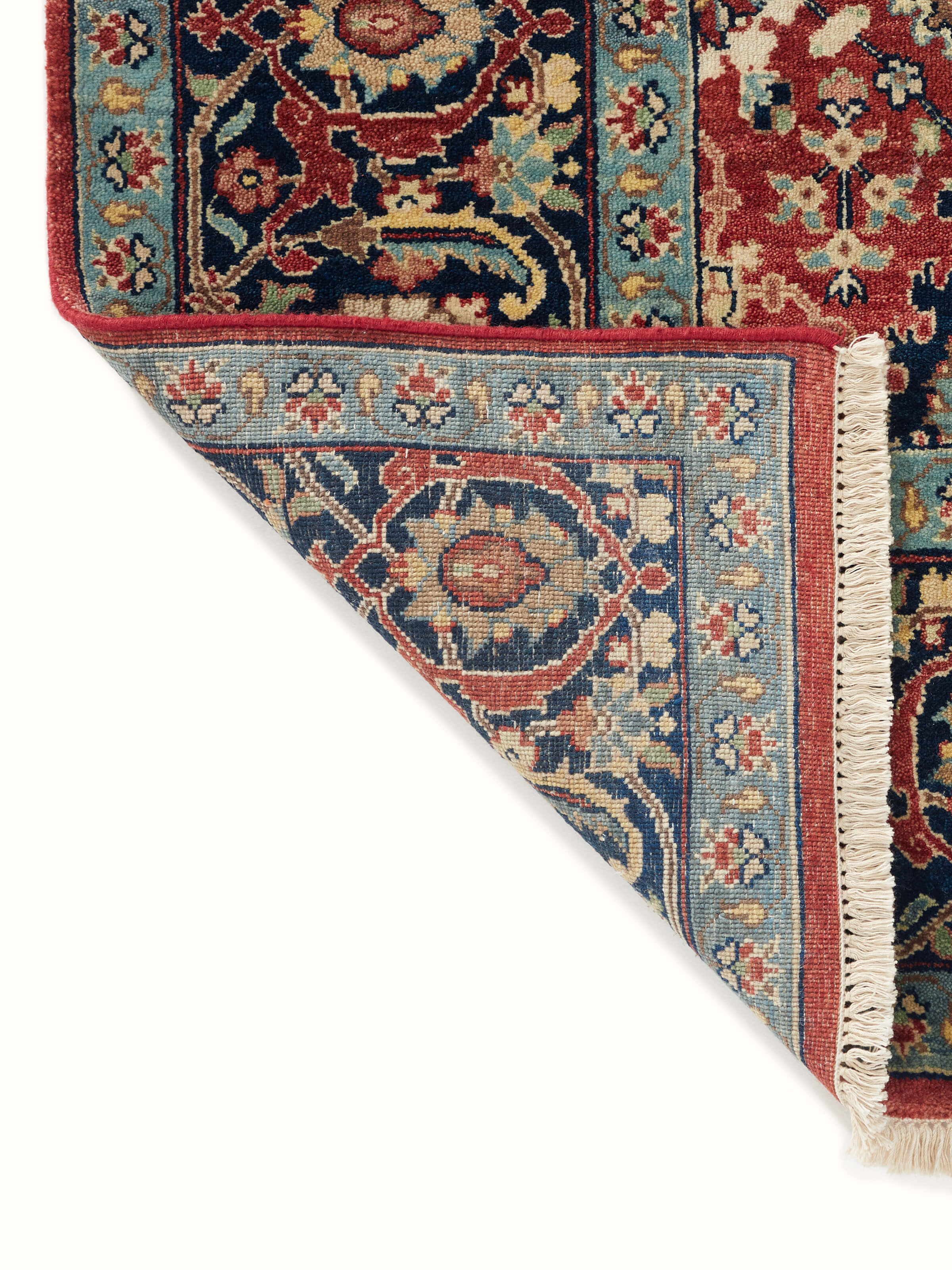 Close-up view of Traditional mahal red Bhadohi wool hand-knotted rug emphasizing the rug’s texture and detail