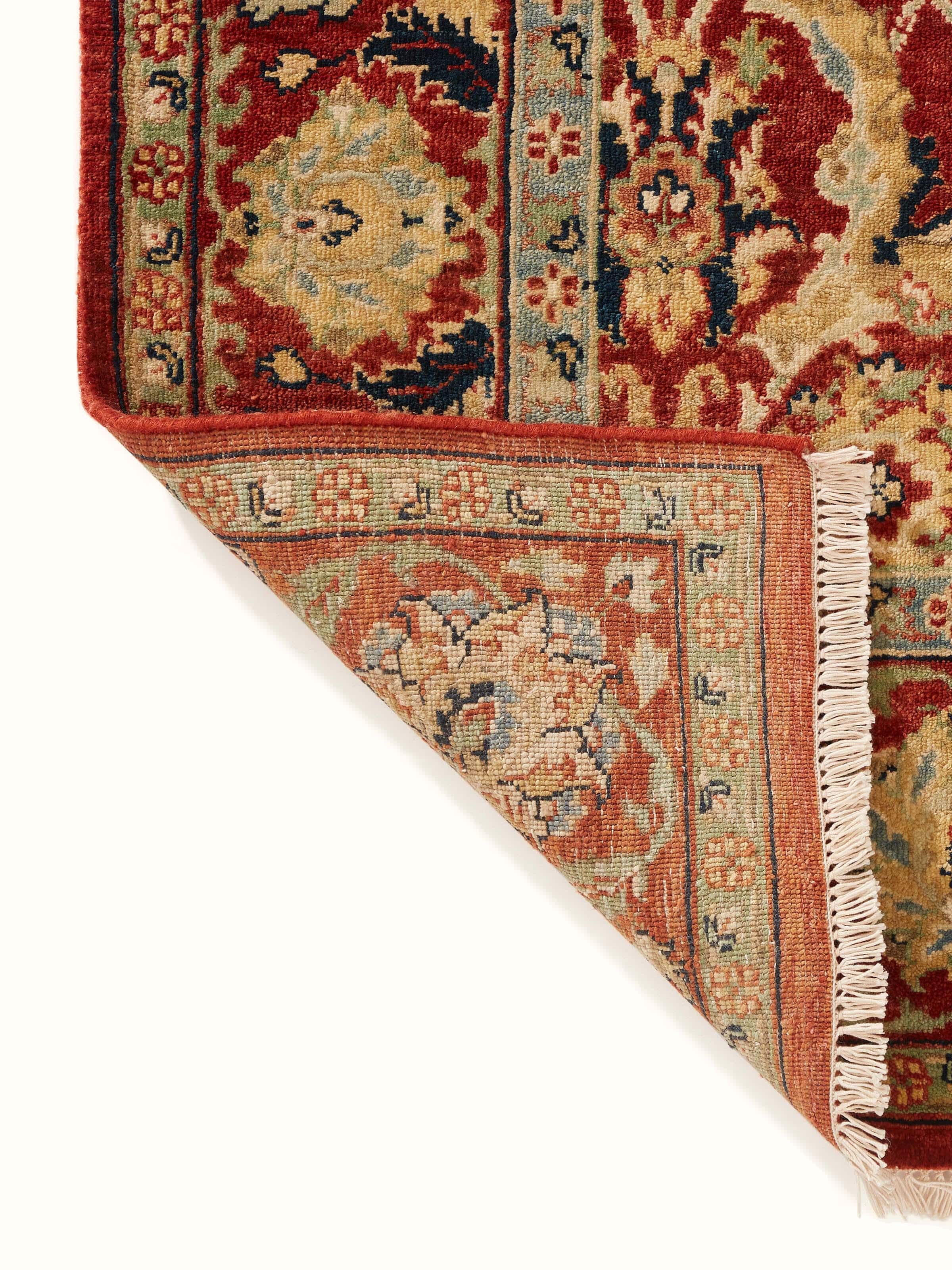 Perspective view of Traditional Polonise rust Bhadohi wool hand-knotted rug illustrating the full pattern and texture.