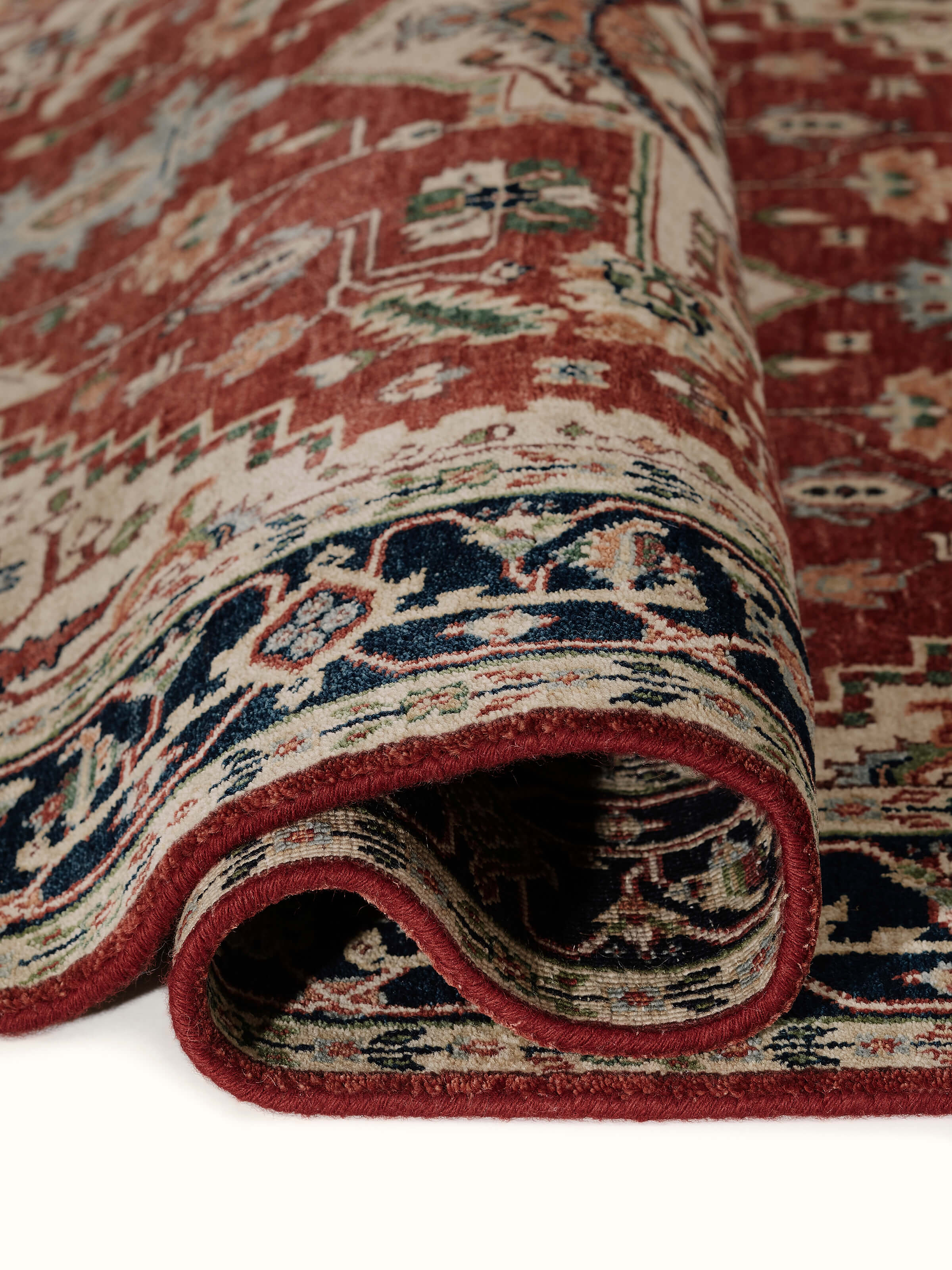 Close-up view of Traditional Heriz rust Bhadohi wool hand-knotted rug emphasizing texture and weave