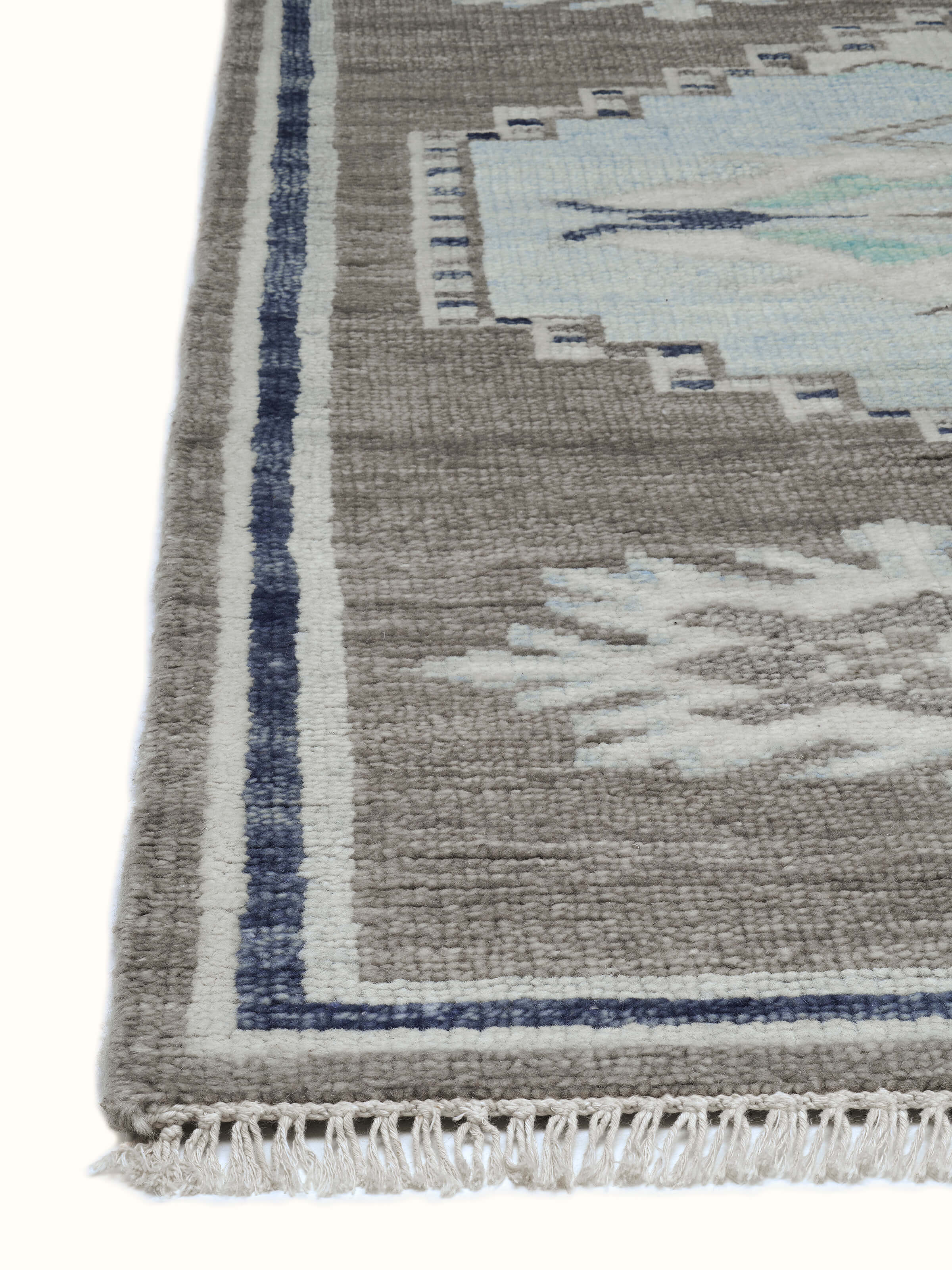 Detailed view of the Traditional Oushak Grey Blue Bhadohi Wool Hand-Knotted Rug, focusing on the intricate patterns and colors.
