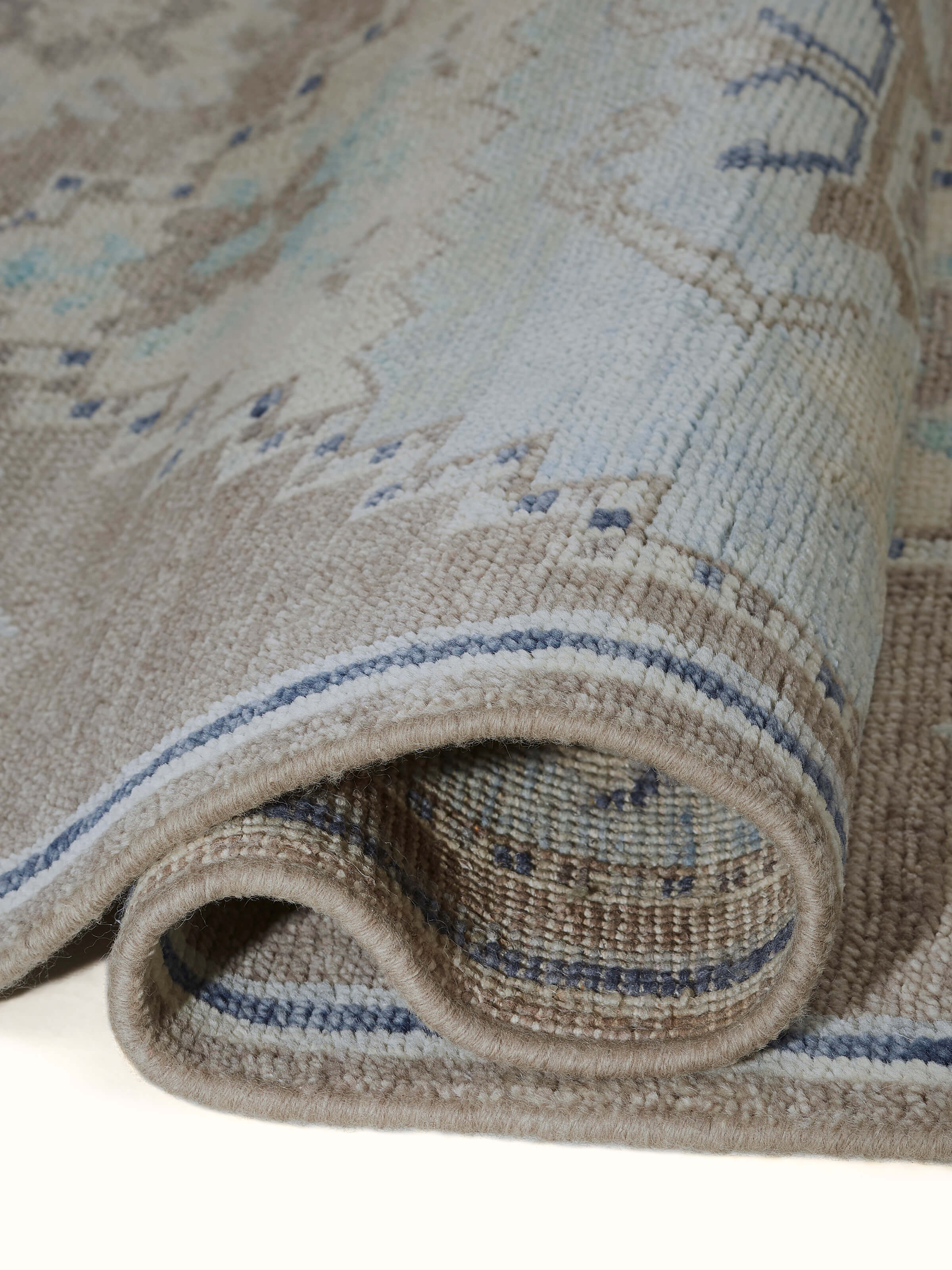 Traditional Oushak Grey Blue Bhadohi Wool Hand-Knotted Rug, displayed in a room to show its size and placement.