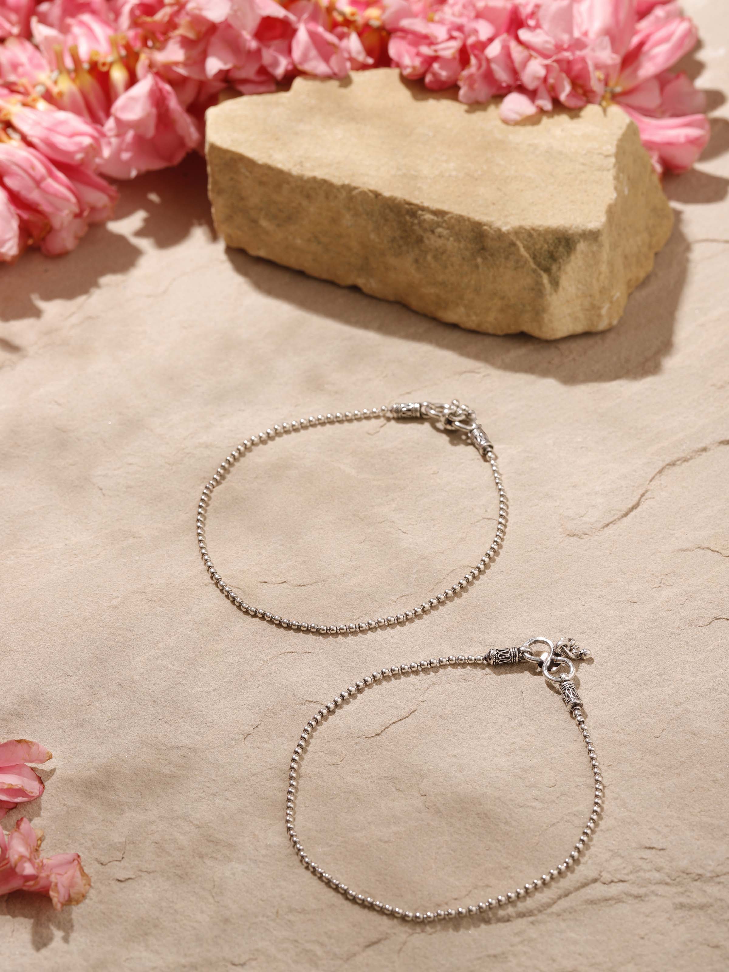 Overhead view of Silver Smithing Anklets emphasizing the elegant design and silver texture.