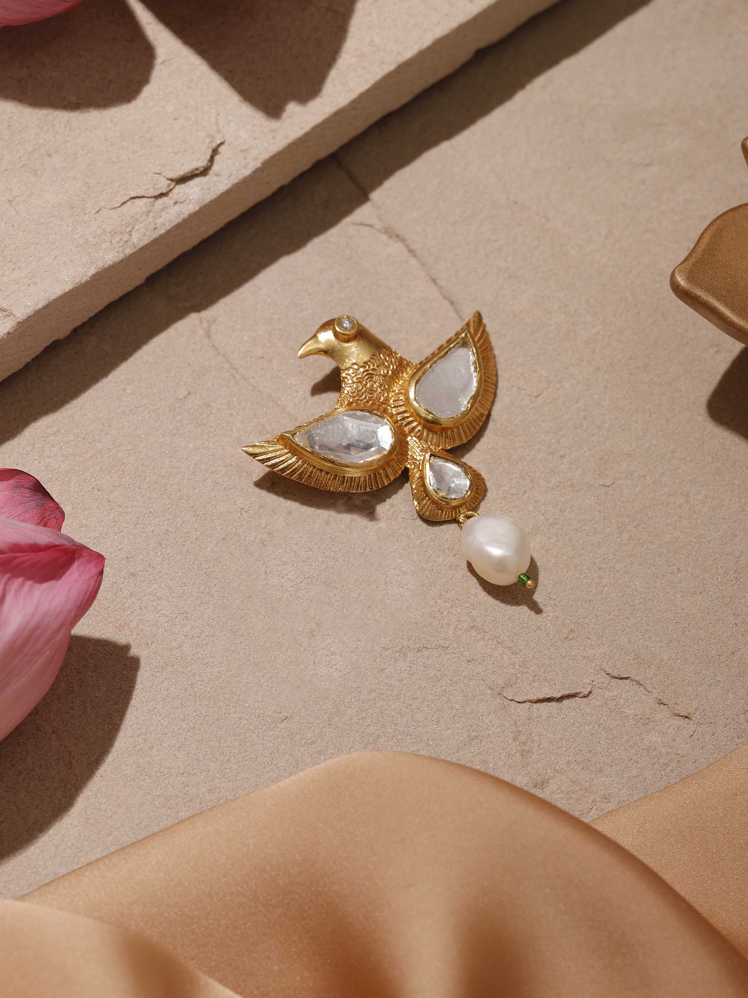 Angled view of Silver Smithing brooch pin on fabric, featuring its sculpted curve and hammered detail.