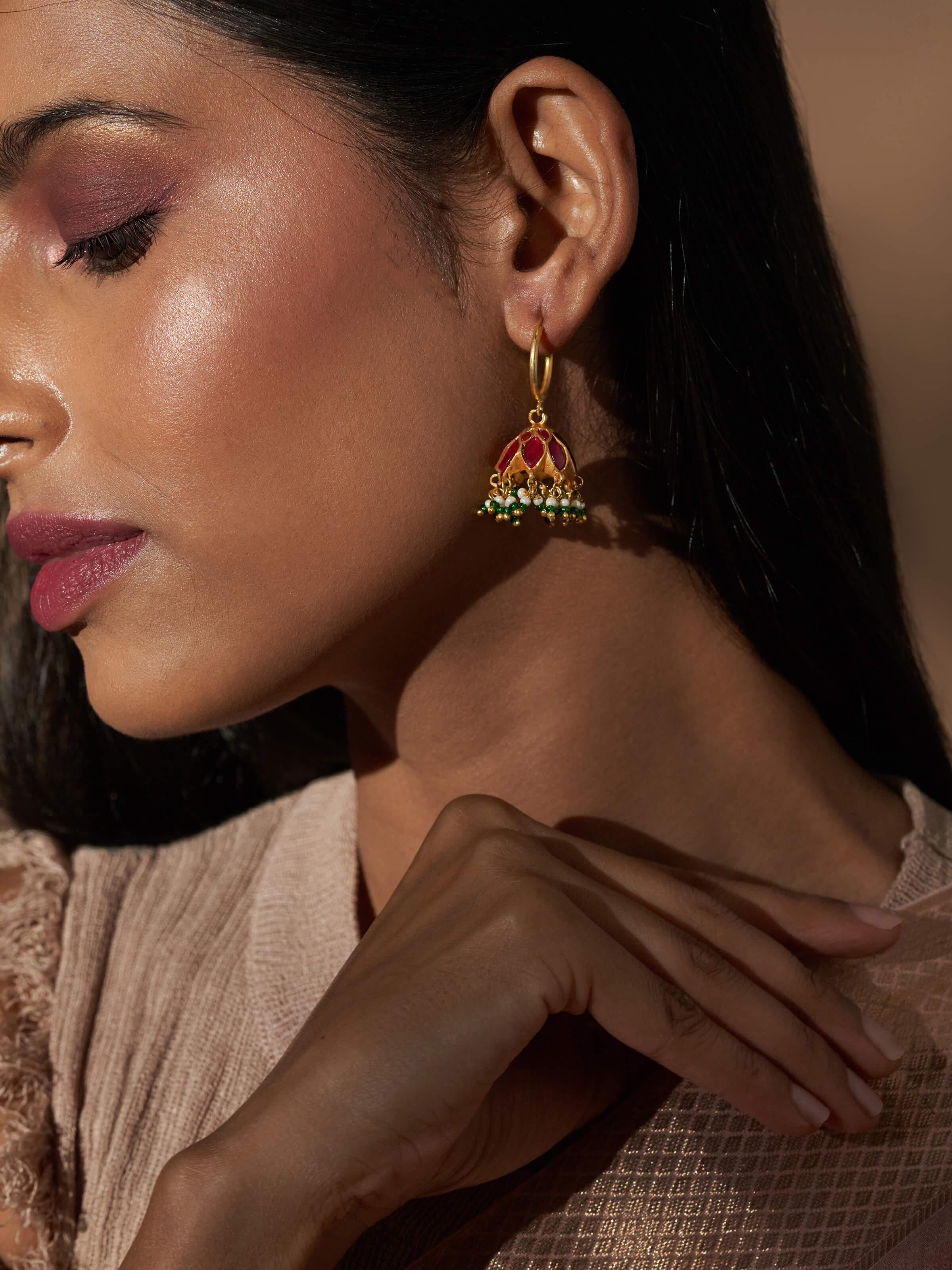 Close-up lifestyle view of Silver Smithing earrings showing side curve and brushed metal finish.