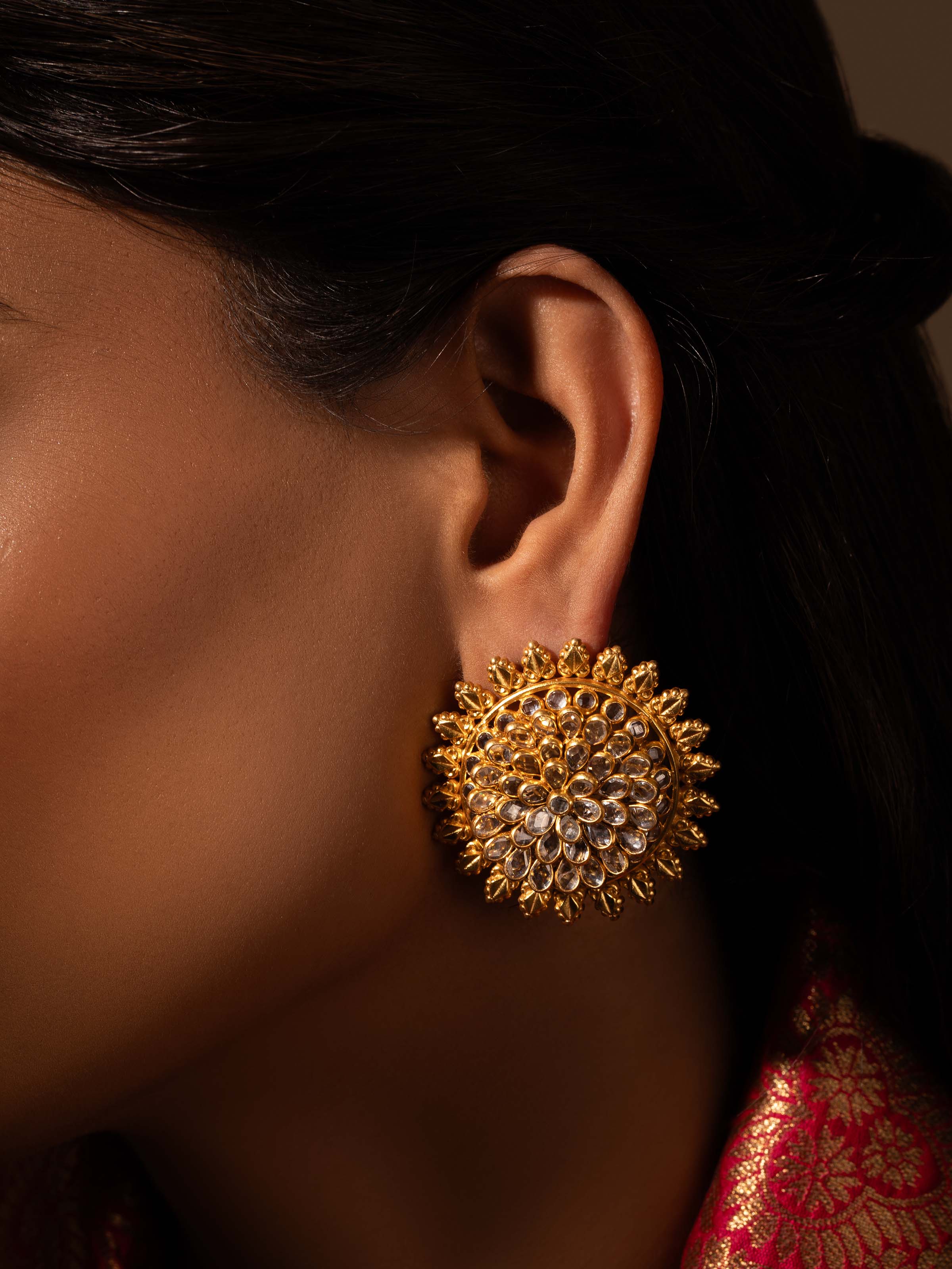 Close-up view of silver smithing stud earrings highlighting detailed texture and high-quality silver work