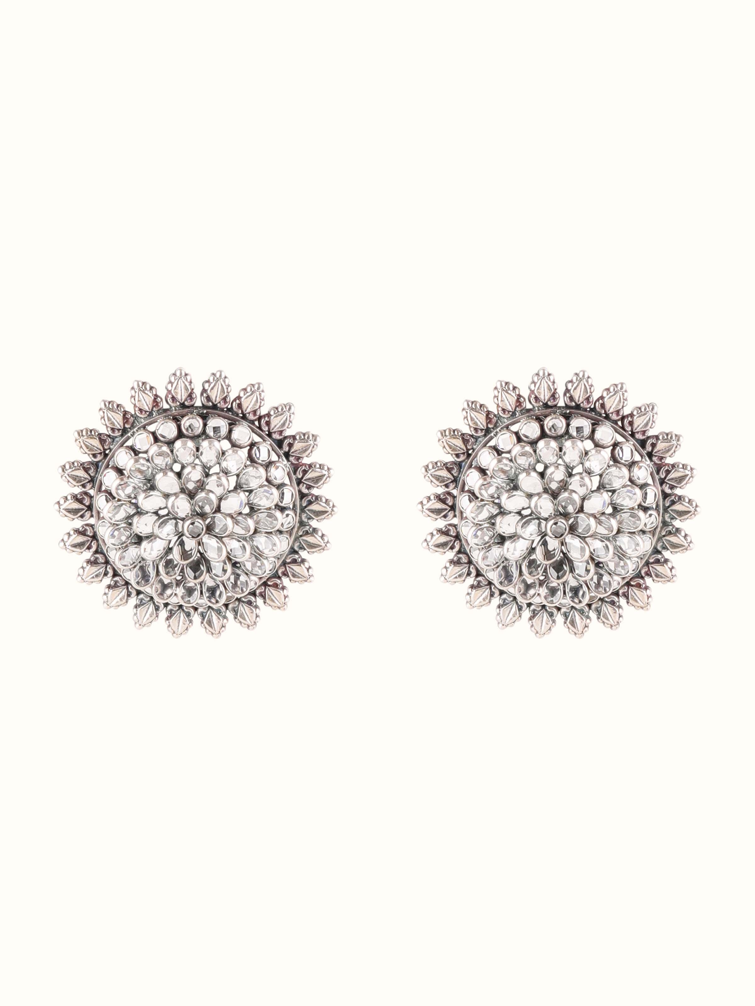 Front view of Smithing Stud Earrings highlighting detailed silver craftsmanship.