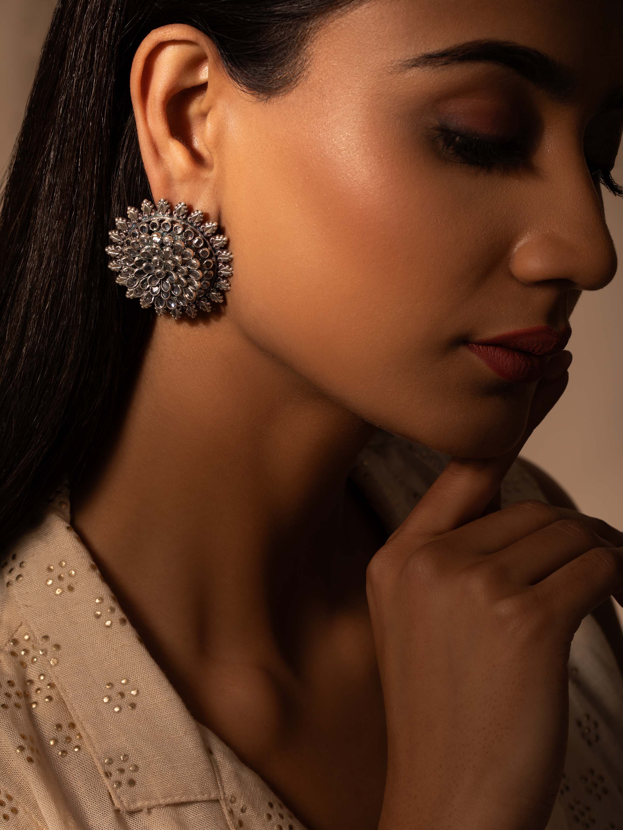 Side view of Smithing Stud Earrings displaying elegant design and silver finish.