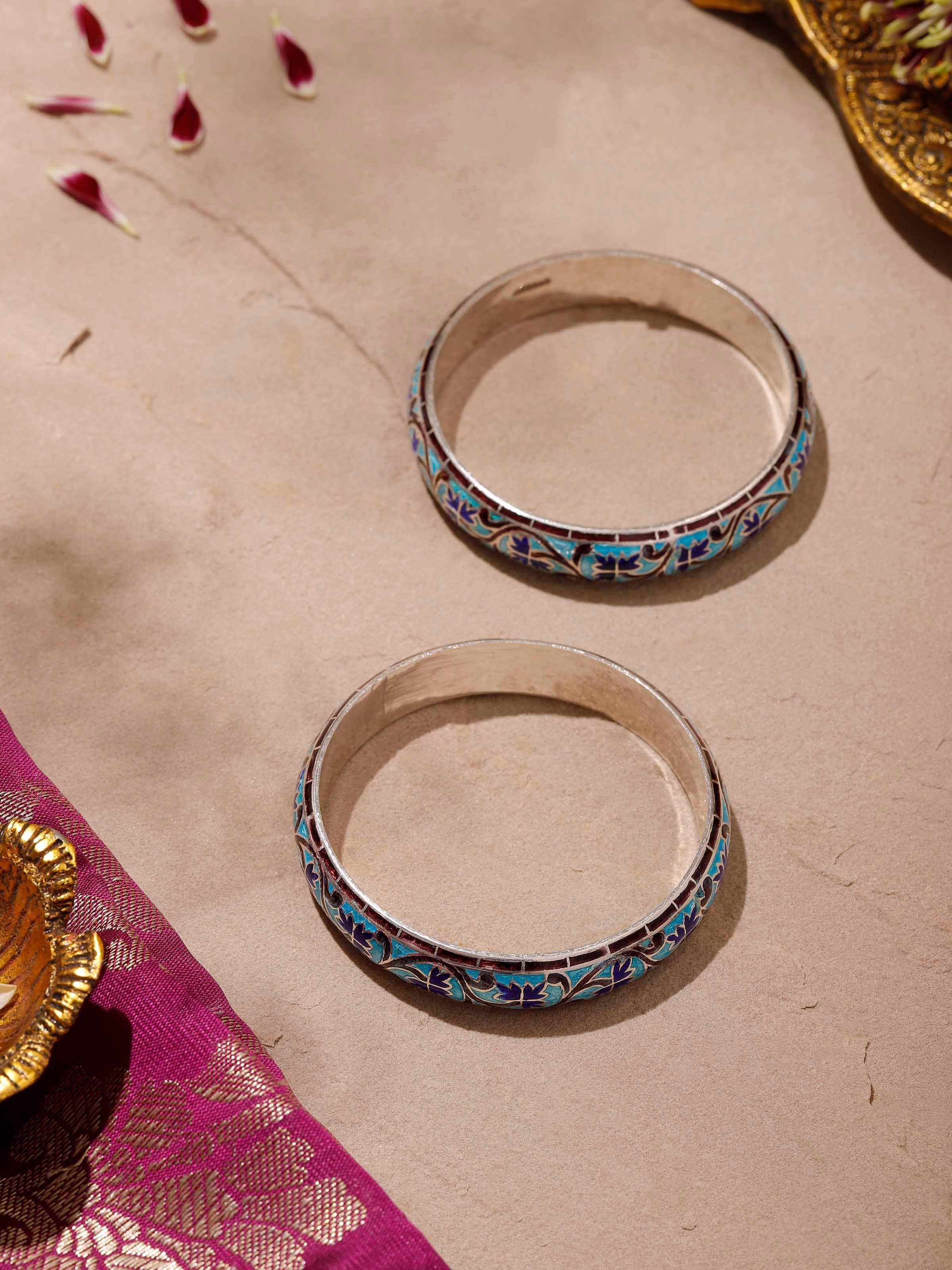 Close-up view of Blue Meenakari Silver Bangles highlighting the intricate blue enamel design and silver patterns.