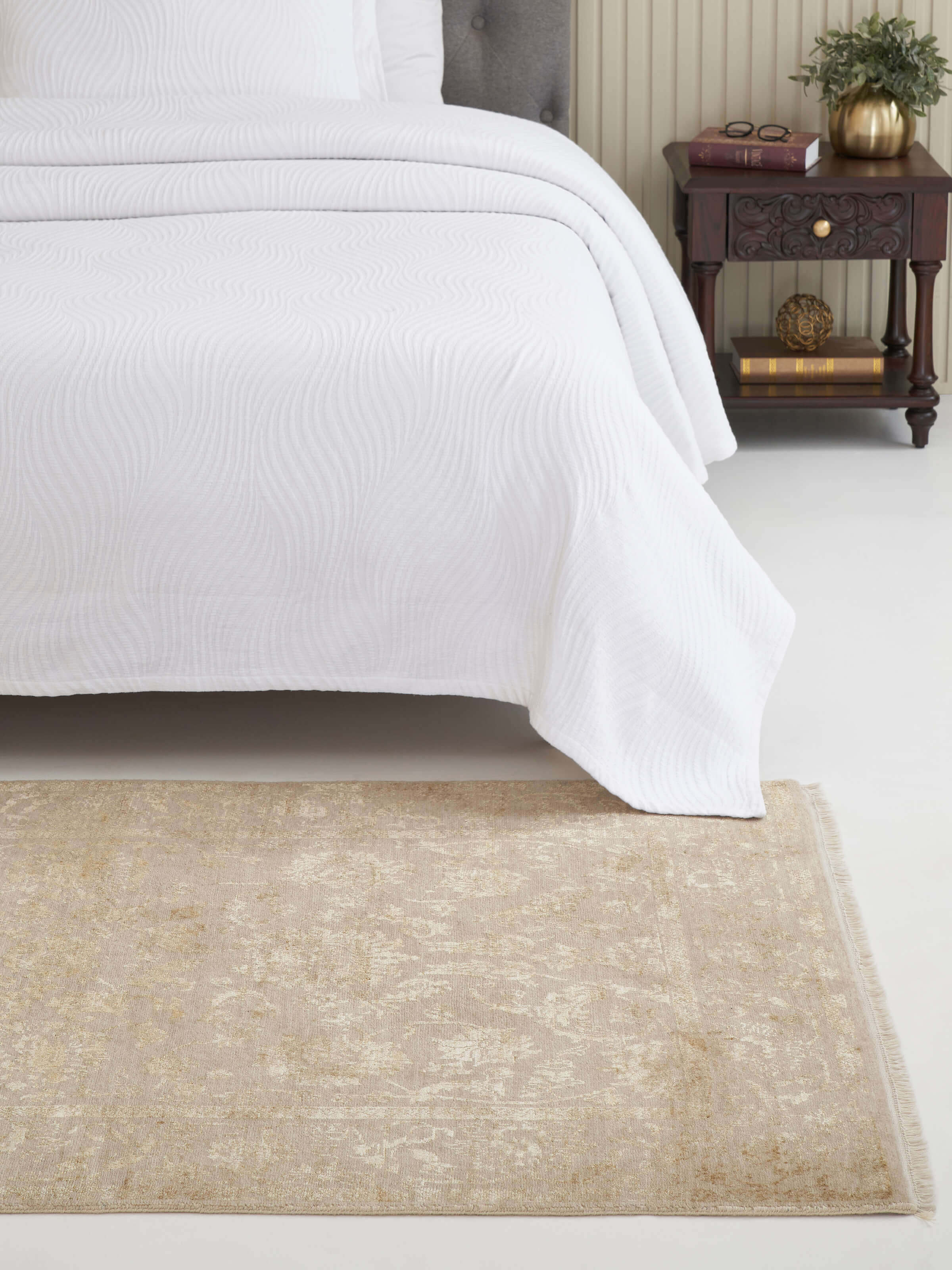 Lifestyle view of gold Agra hand-knotted rug featuring a distressed transitional design in wool and viscose.