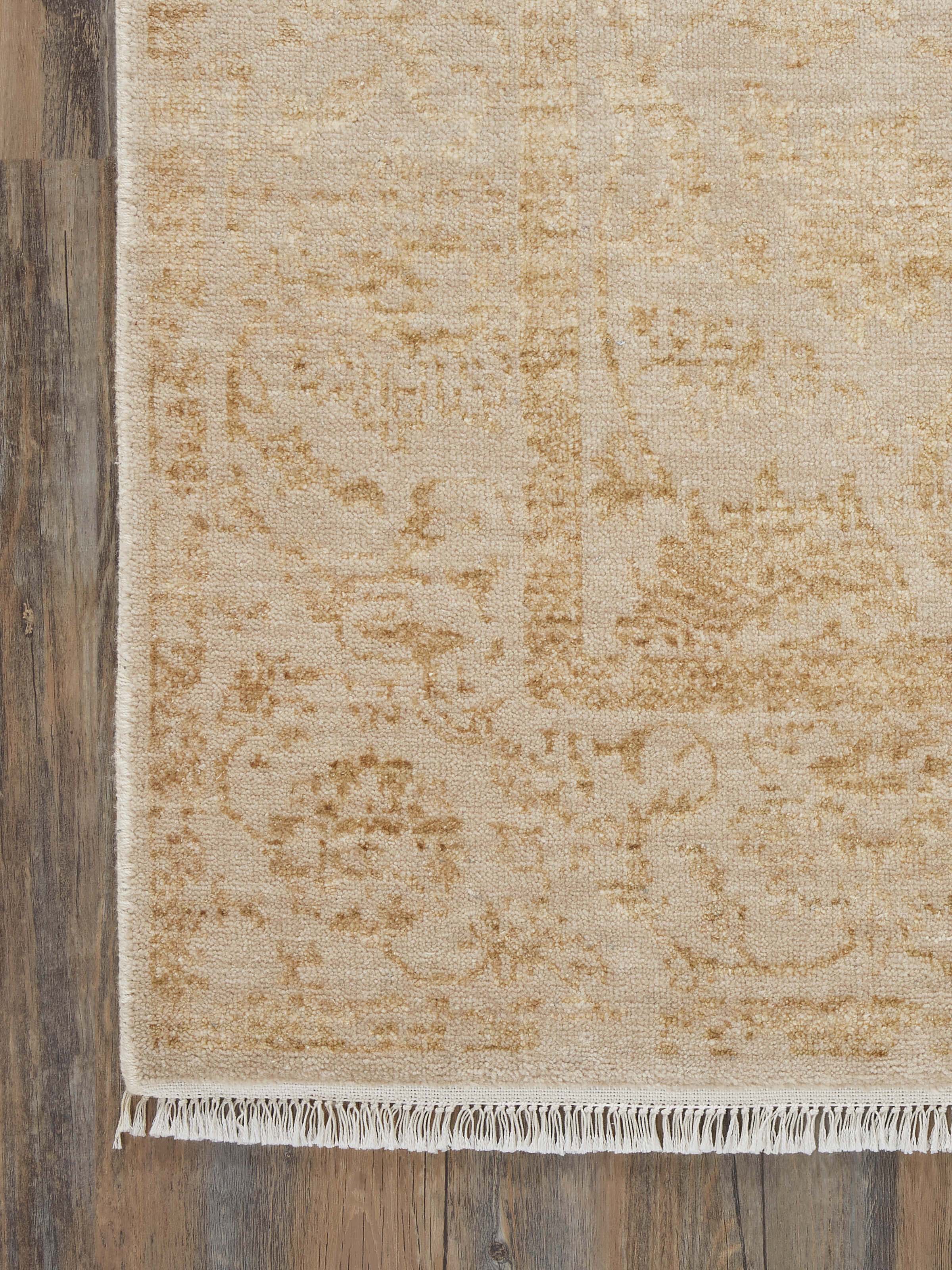 Detailed close-up of the rug's distressed gold pattern and texture, illustrating the fine craftsmanship of the hand-knotted weave