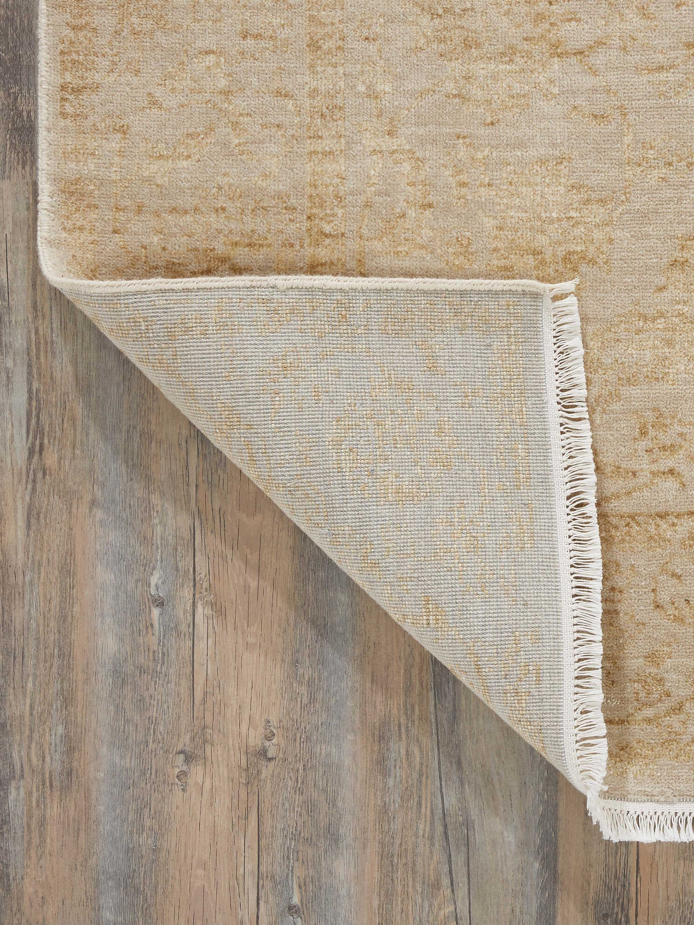 Full view of the gold Agra rug in a room setting, demonstrating its elegant presence and ability to complement various decor styles