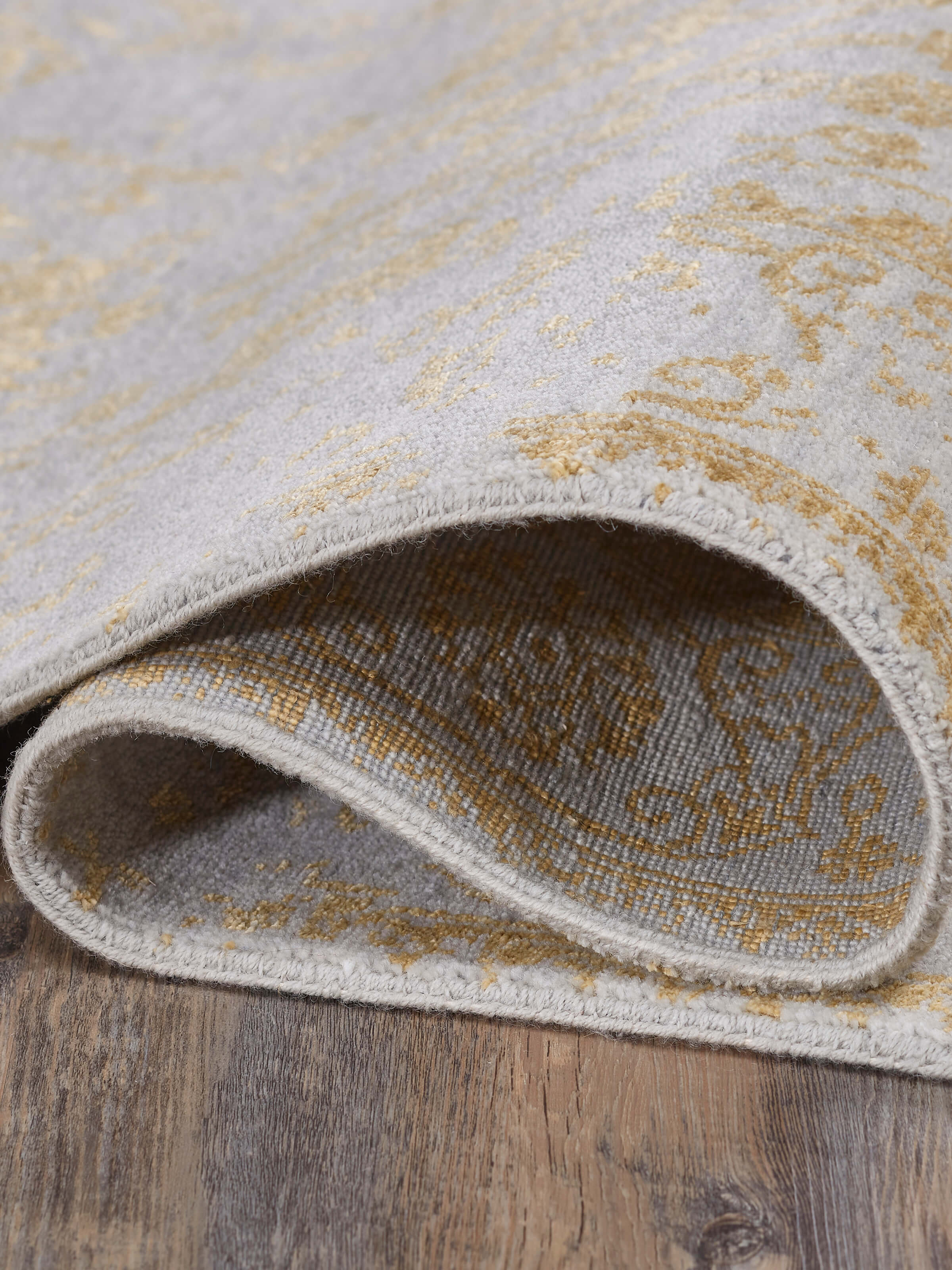 Detailed view of Distressed Transitional Grey Gold Agra Wool & Viscose Hand-Knotted Rug, focusing on the distressed effect and color depth.