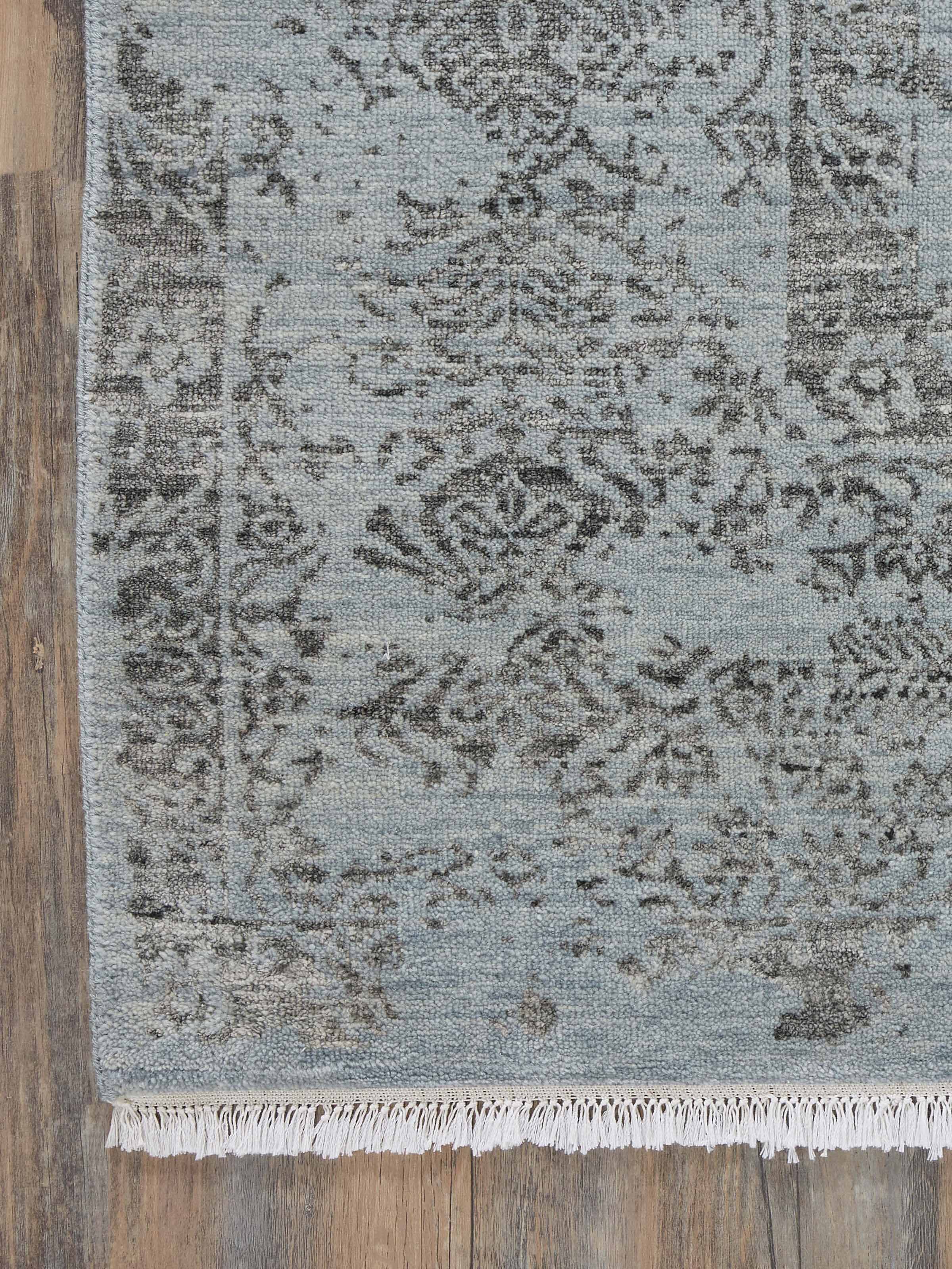 Detailed view of Distressed Transitional Blue Charcoal Agra Wool & Viscose Hand-Knotted Rug focusing on the rug's colors and design.