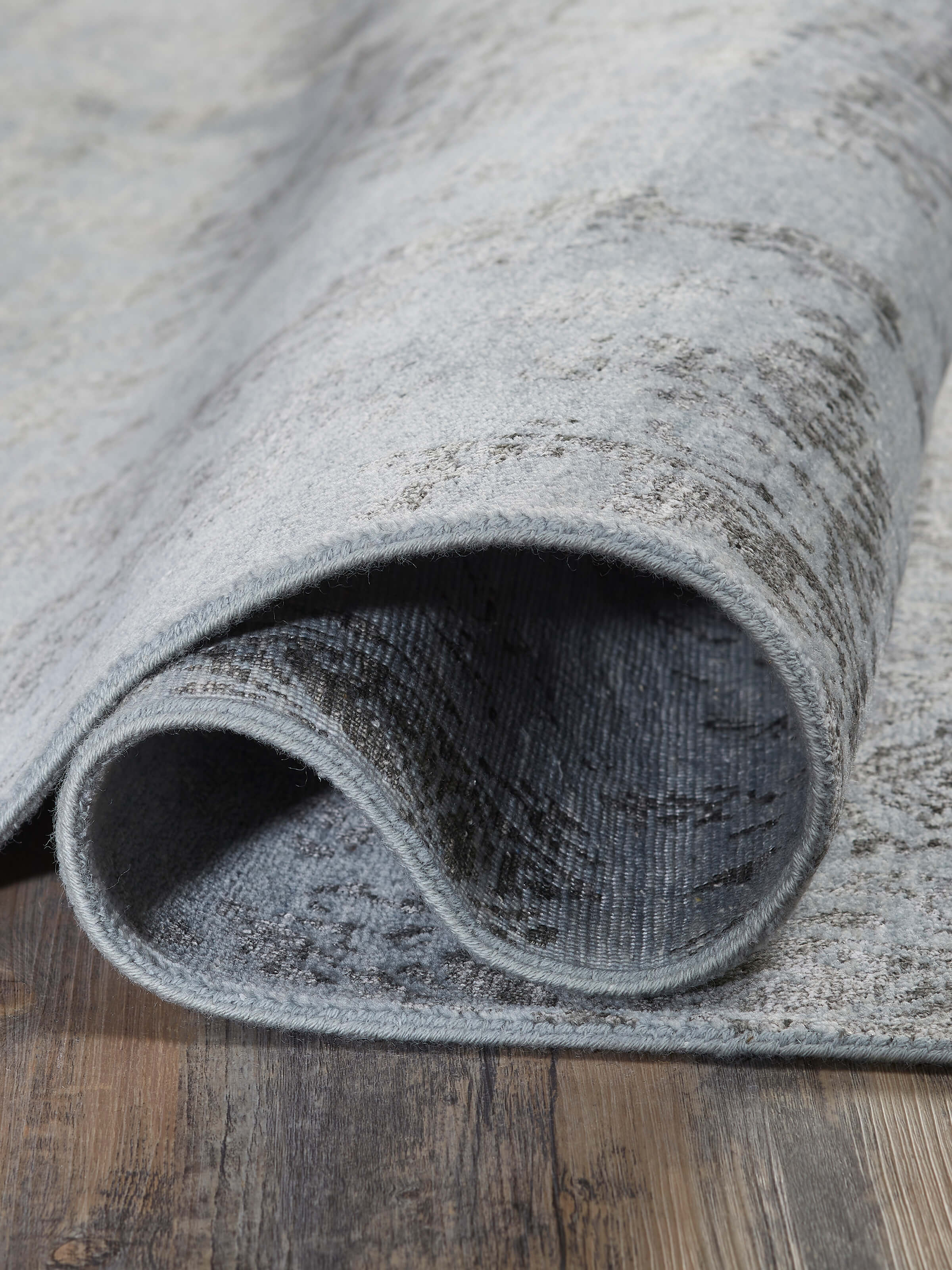 Close-up of Distressed Transitional Blue Charcoal Agra Wool & Viscose Hand-Knotted Rug emphasizing the texture and distressed effect.