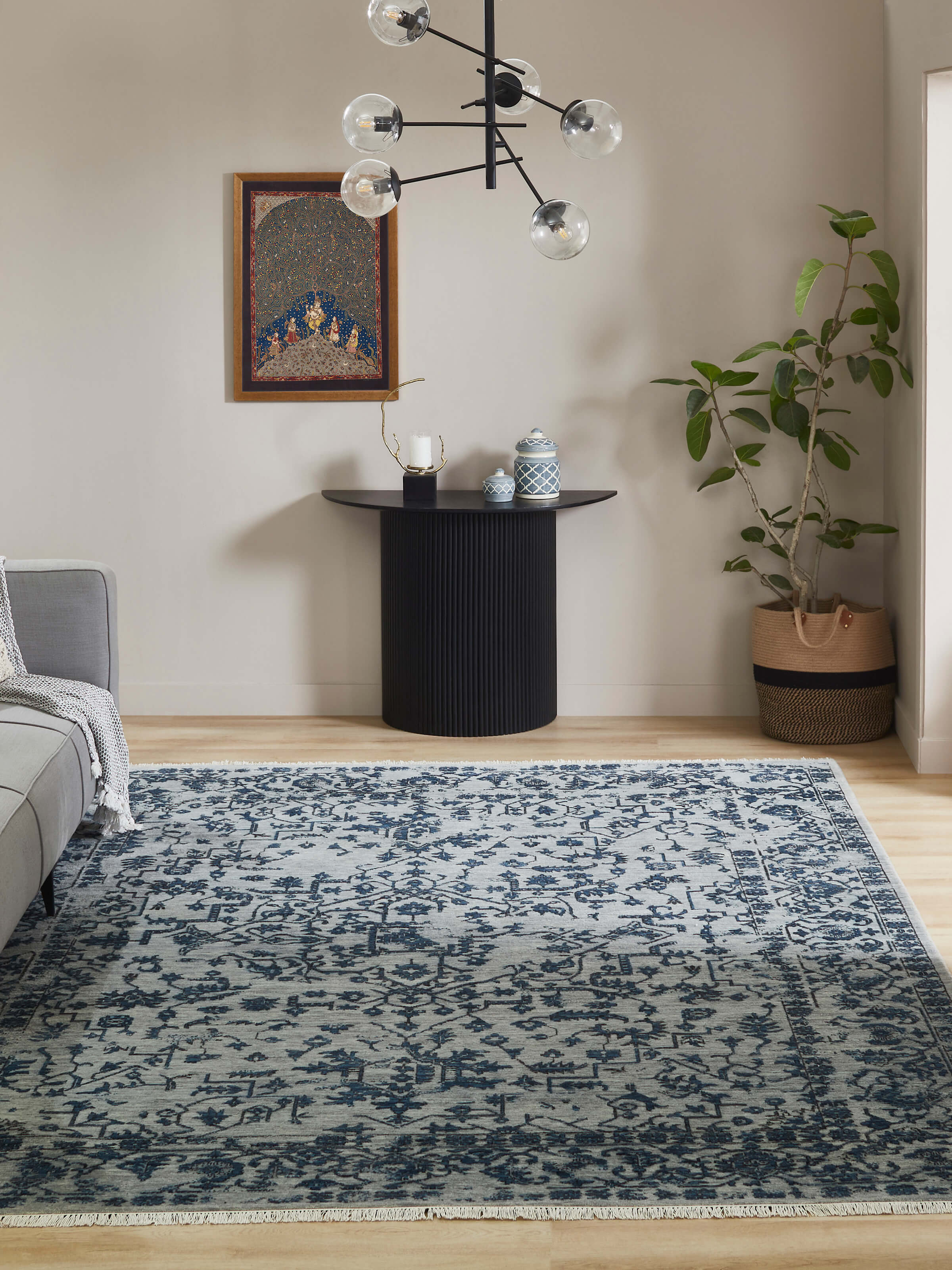 Lifestyle image of Distressed Grey Blue Wool Hand-knotted Rug from Agra, styled in a modern living room setting by Swadesh.