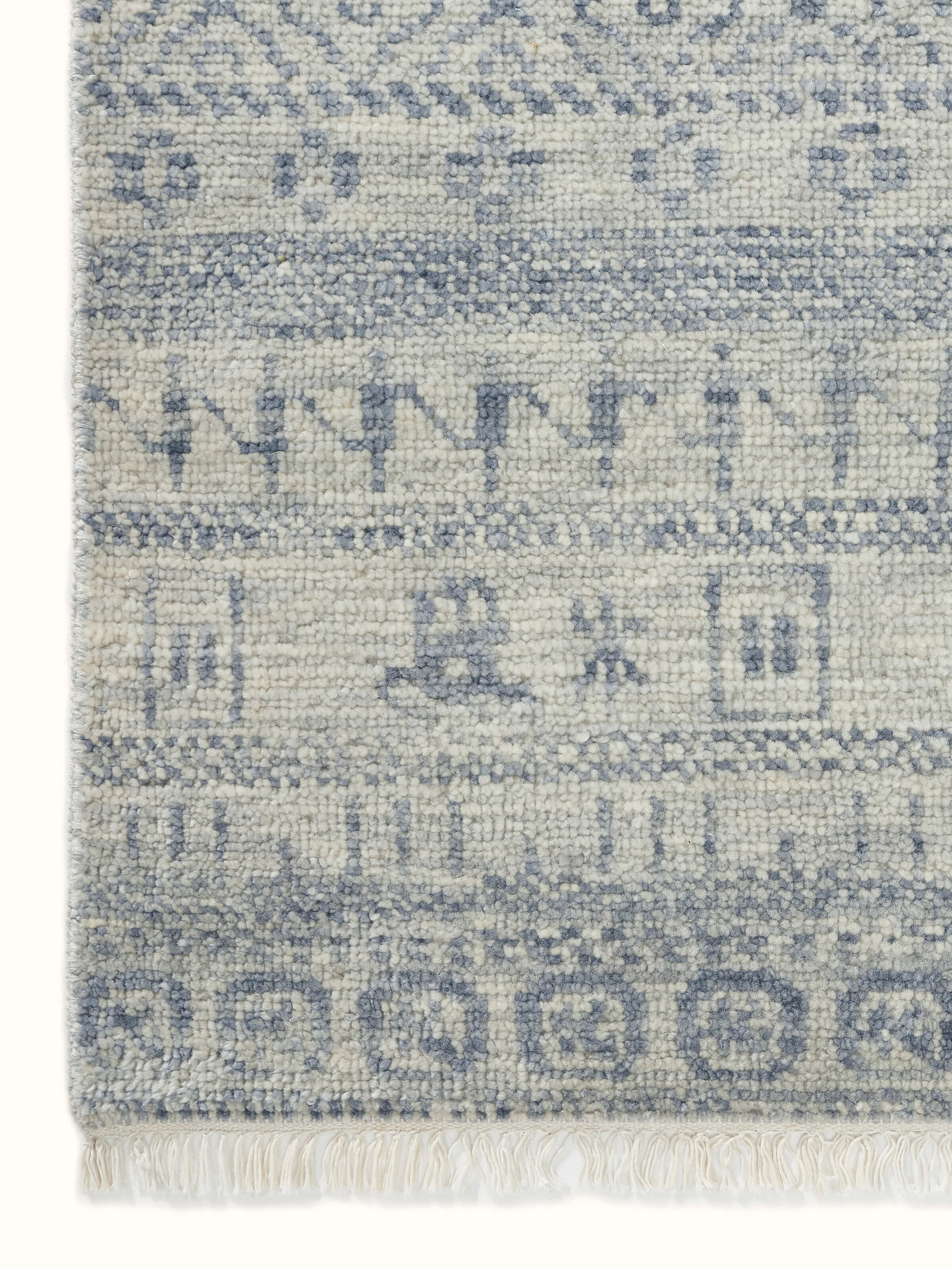 Close-up view of the rug’s hand-knotted details, emphasizing the elegant design and texture of the Agra wool.