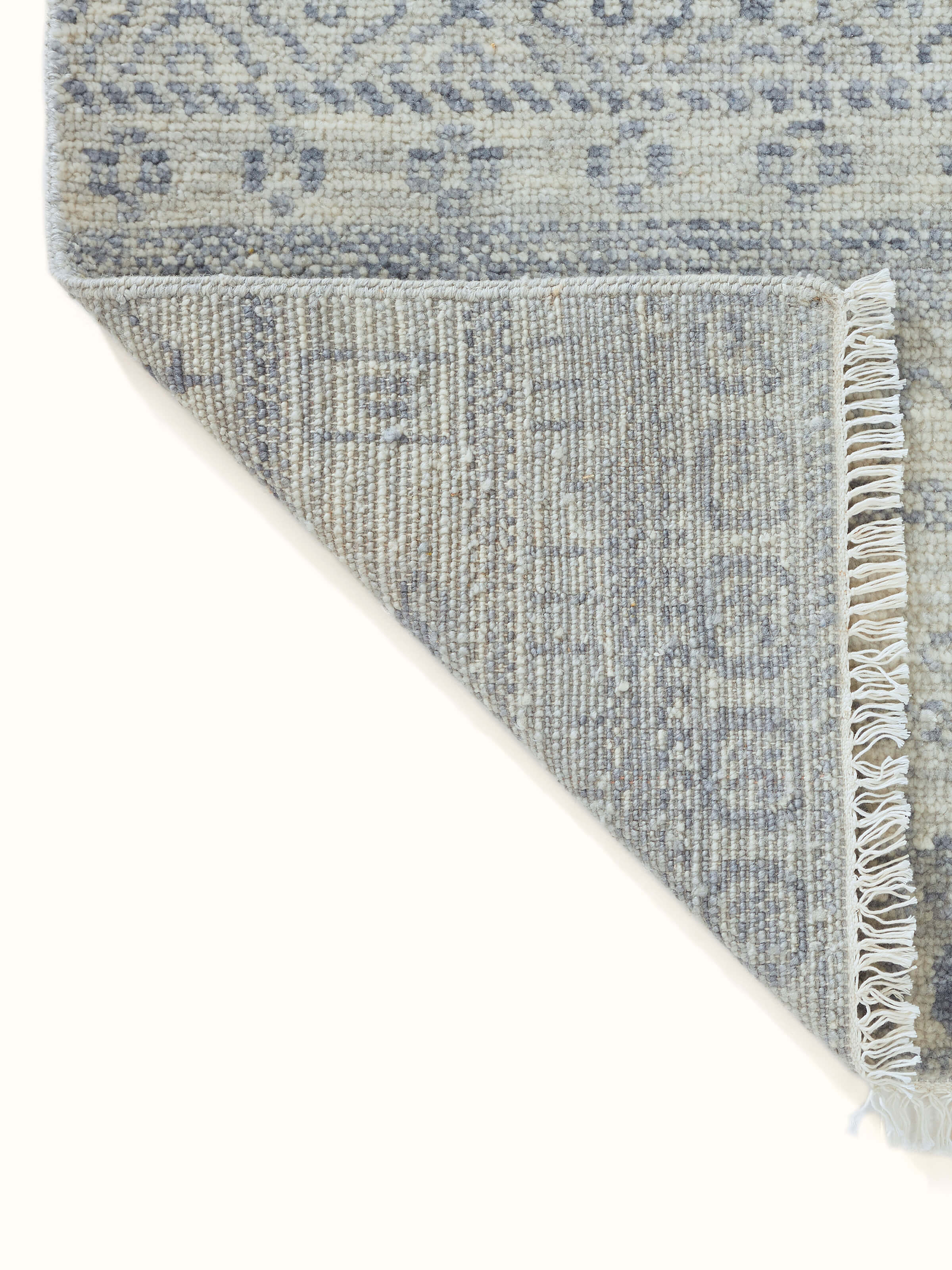 Perspective view of the Bohemian Classic rug, capturing the full scale and intricate pattern of the grey-blue hand-knotted wool.