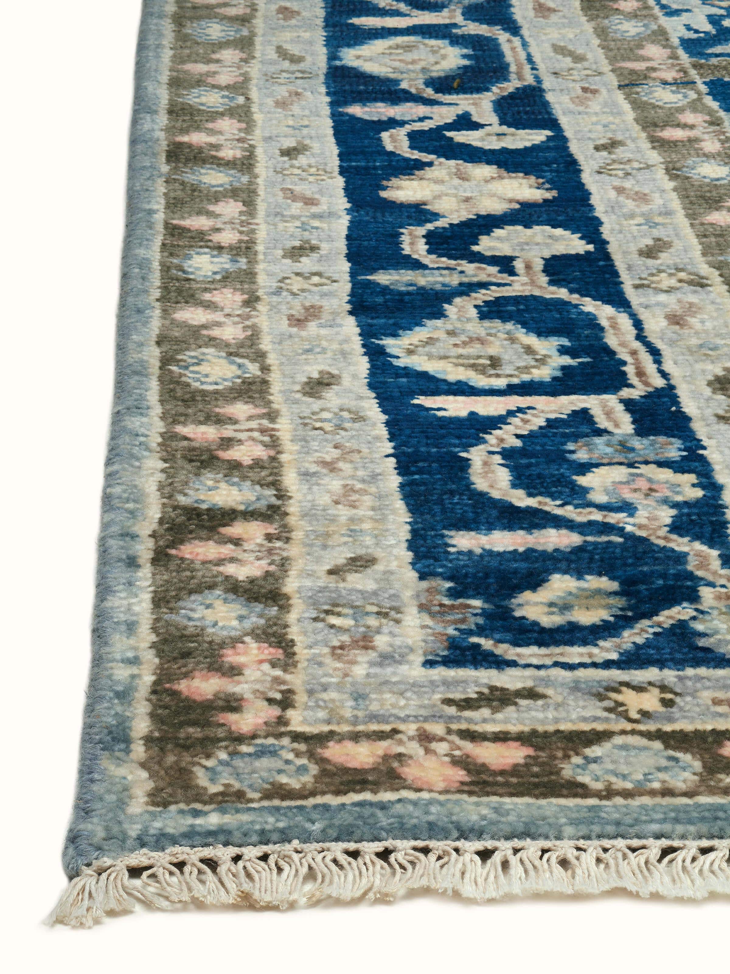 Full view of Oushak blue wool hand-knotted rug highlighting its elaborate design and vibrant color.