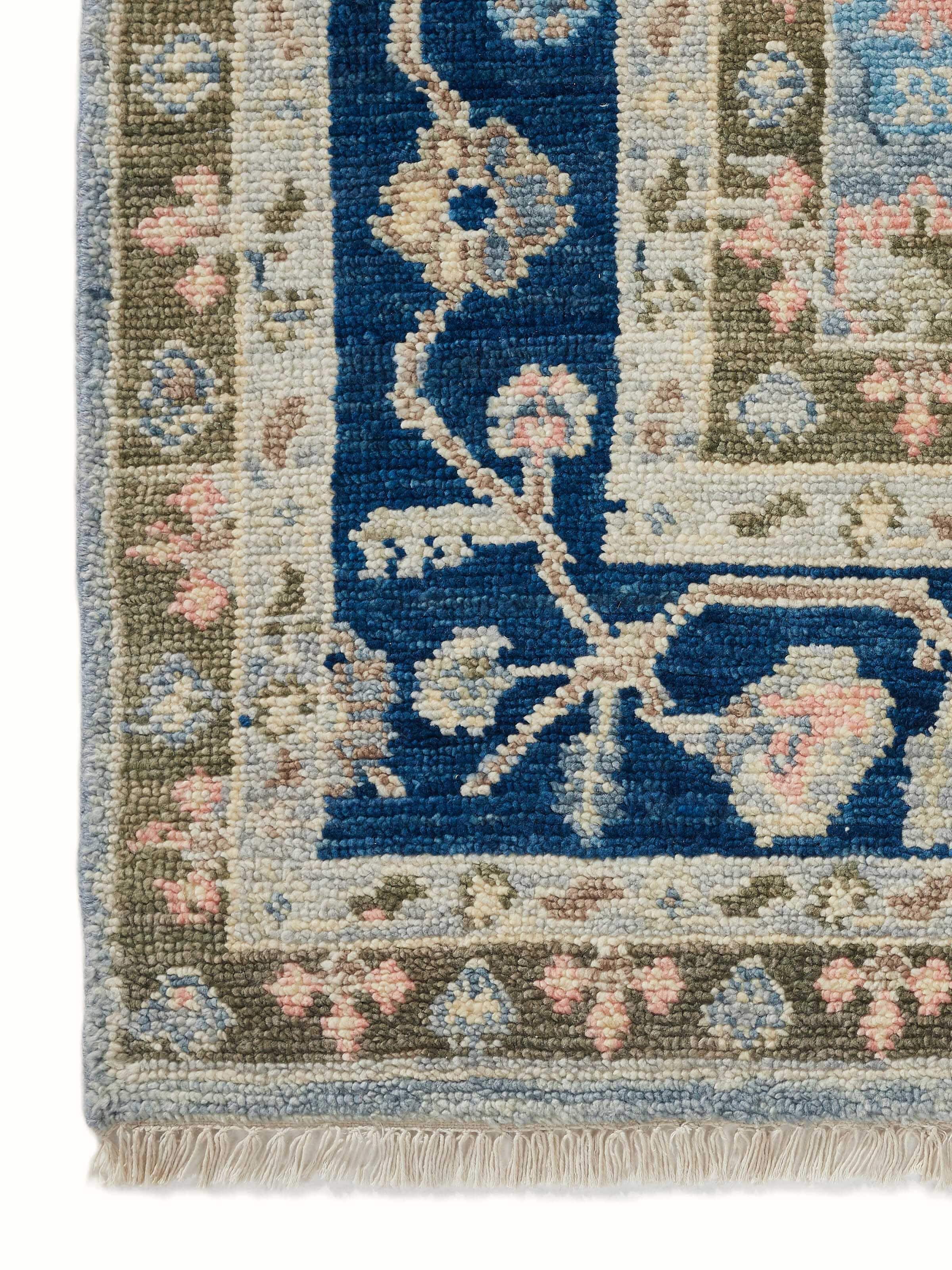 Detailed shot of the Oushak blue wool rug showcasing the texture and intricate knots.