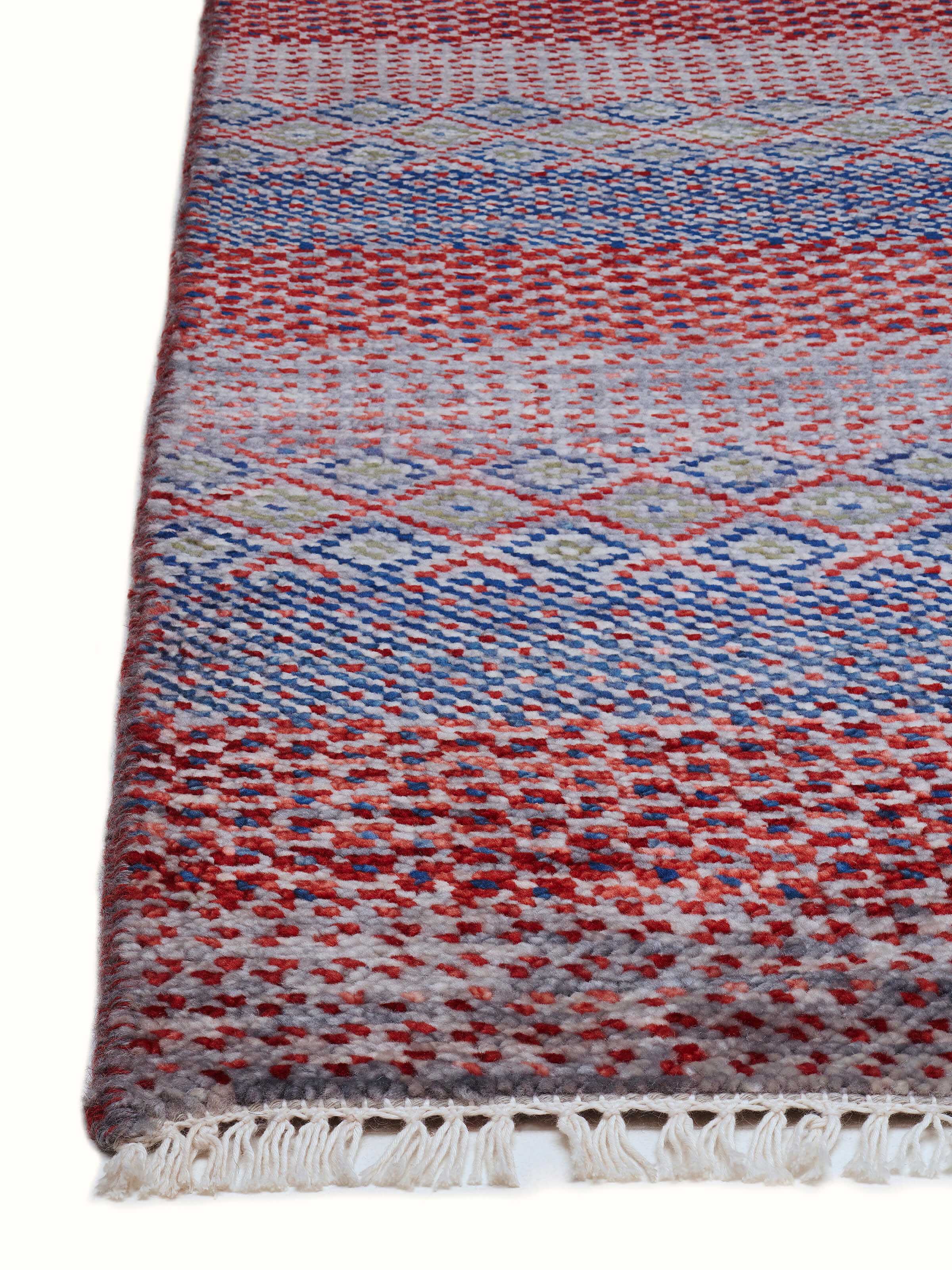 Detailed view of the Agra wool and viscose hand-knotted rug with a focus on the intricate grass pattern and color depth